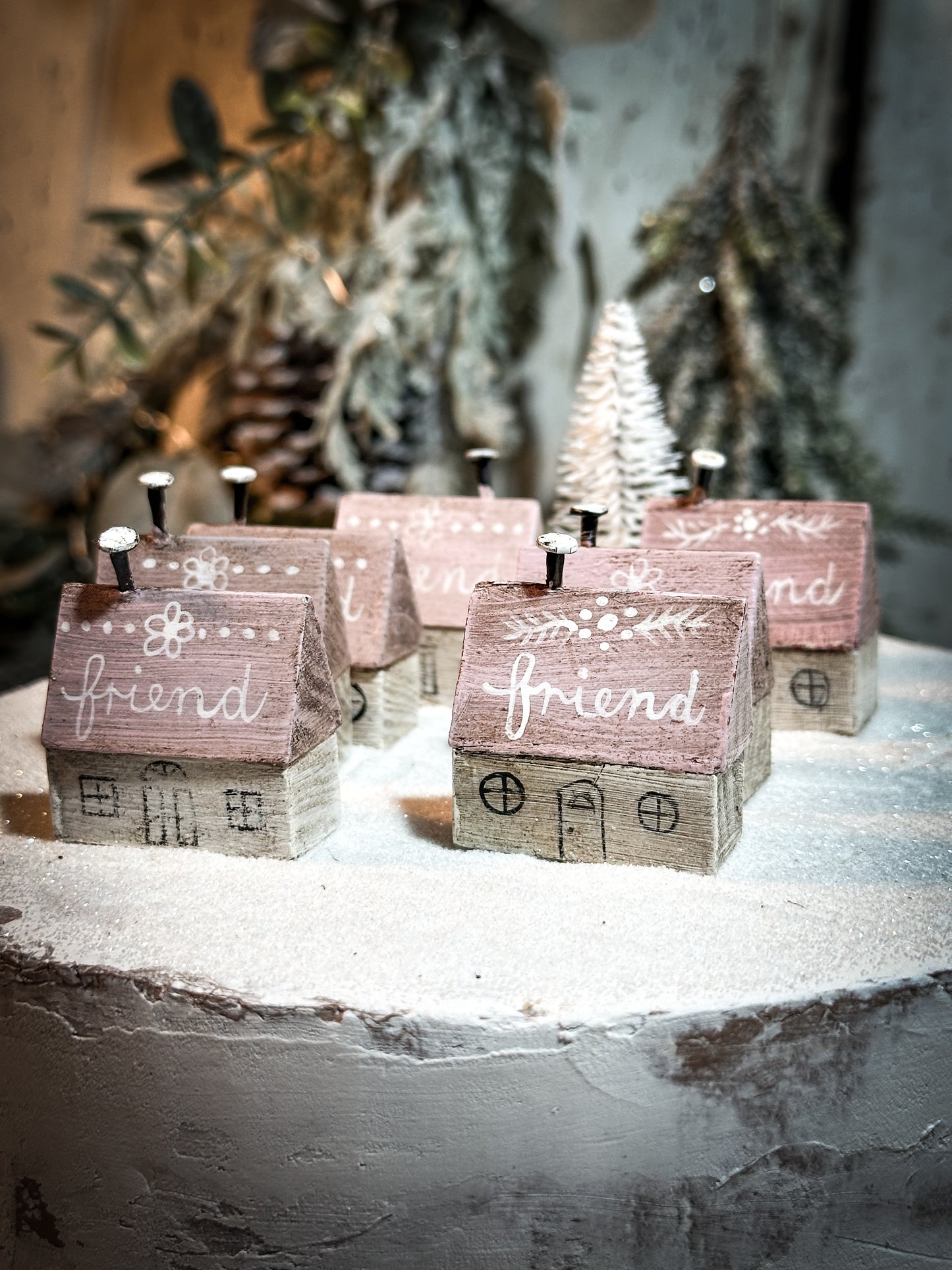 A pretty vintage German Erzgebirge Putz wooden village house painted with a Christmas quote