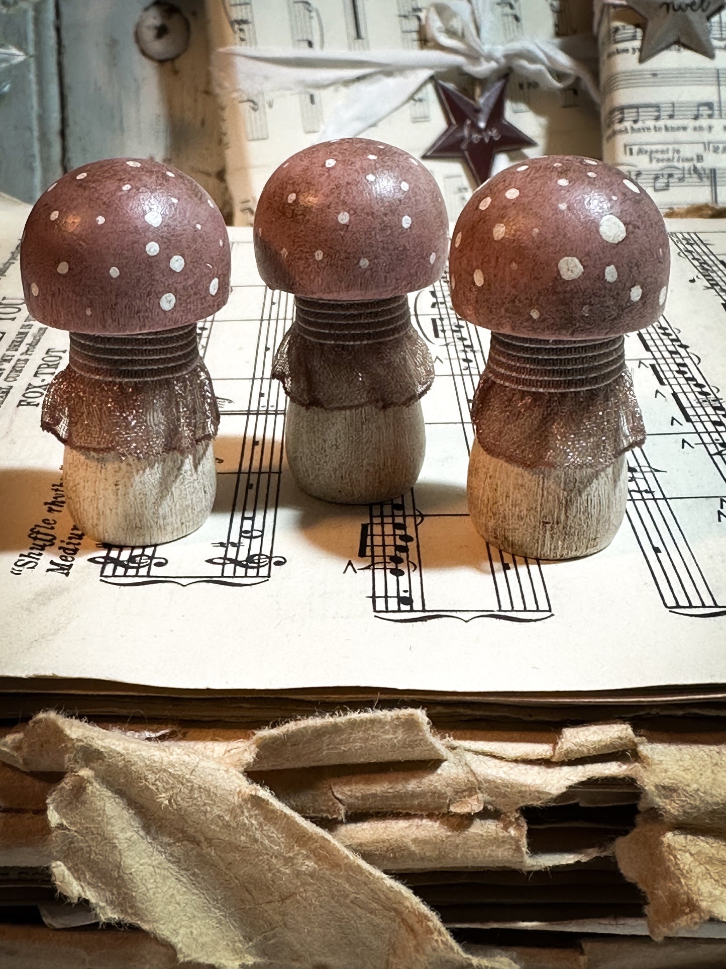 A wooden hand painted and trimmed Christmas village toadstool