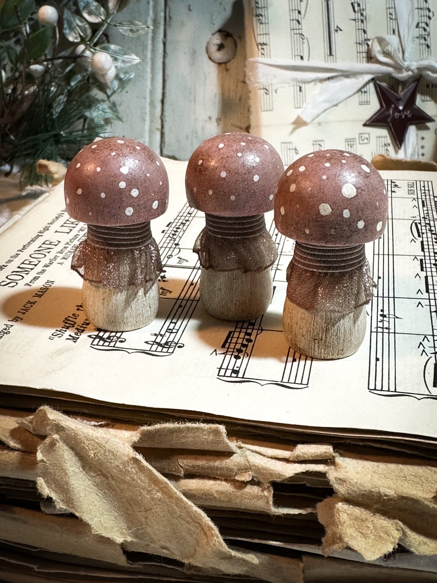 A wooden hand painted and trimmed Christmas village toadstool