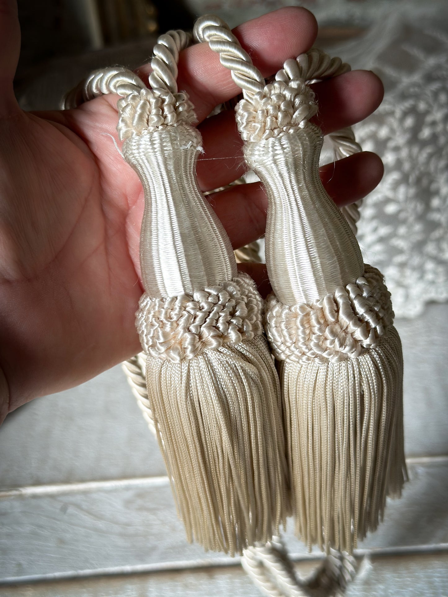 A pair of pretty vintage ivory curtain tie backs