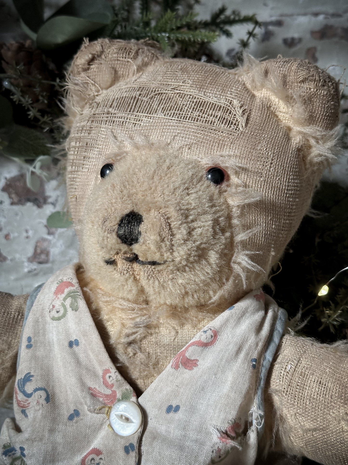 A lovely antique teddy made in original cotton pyjamas
