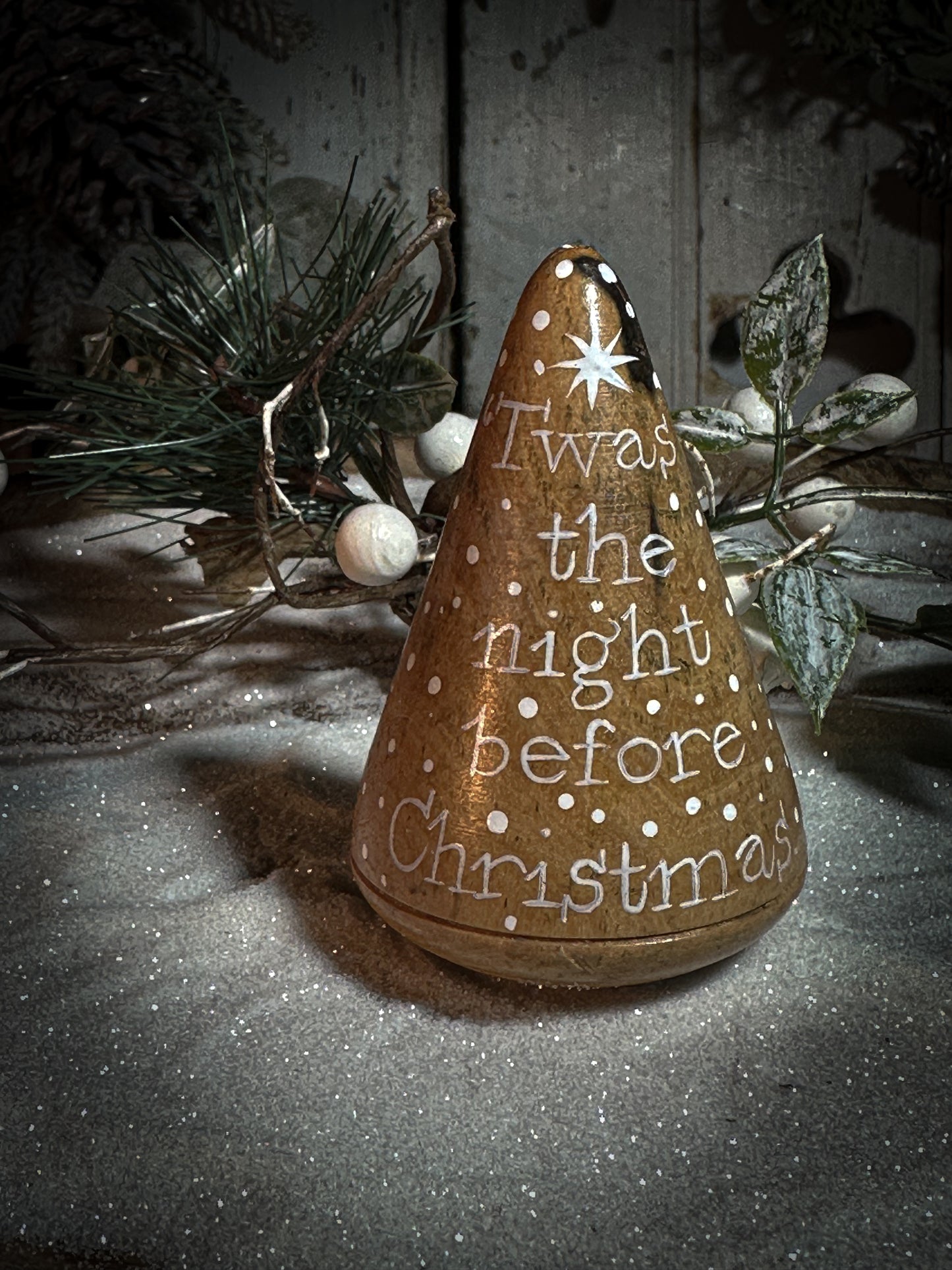 A hand painted quote on a lignum vitae wood plumber’s turnpin with a Christmas quote