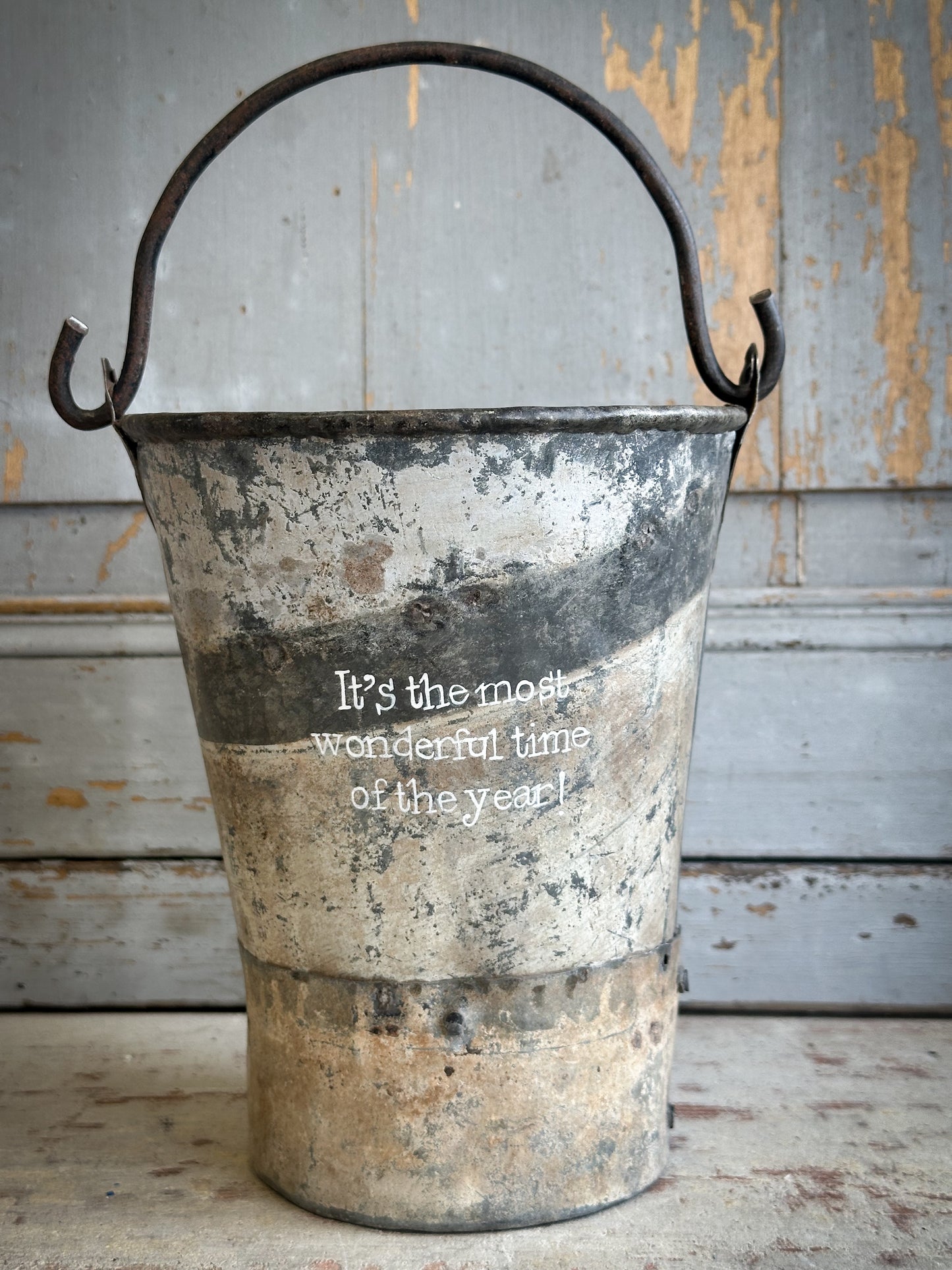 A Recycled Metal Mini Christmas Tree Bucket With A Hand Painted Quote