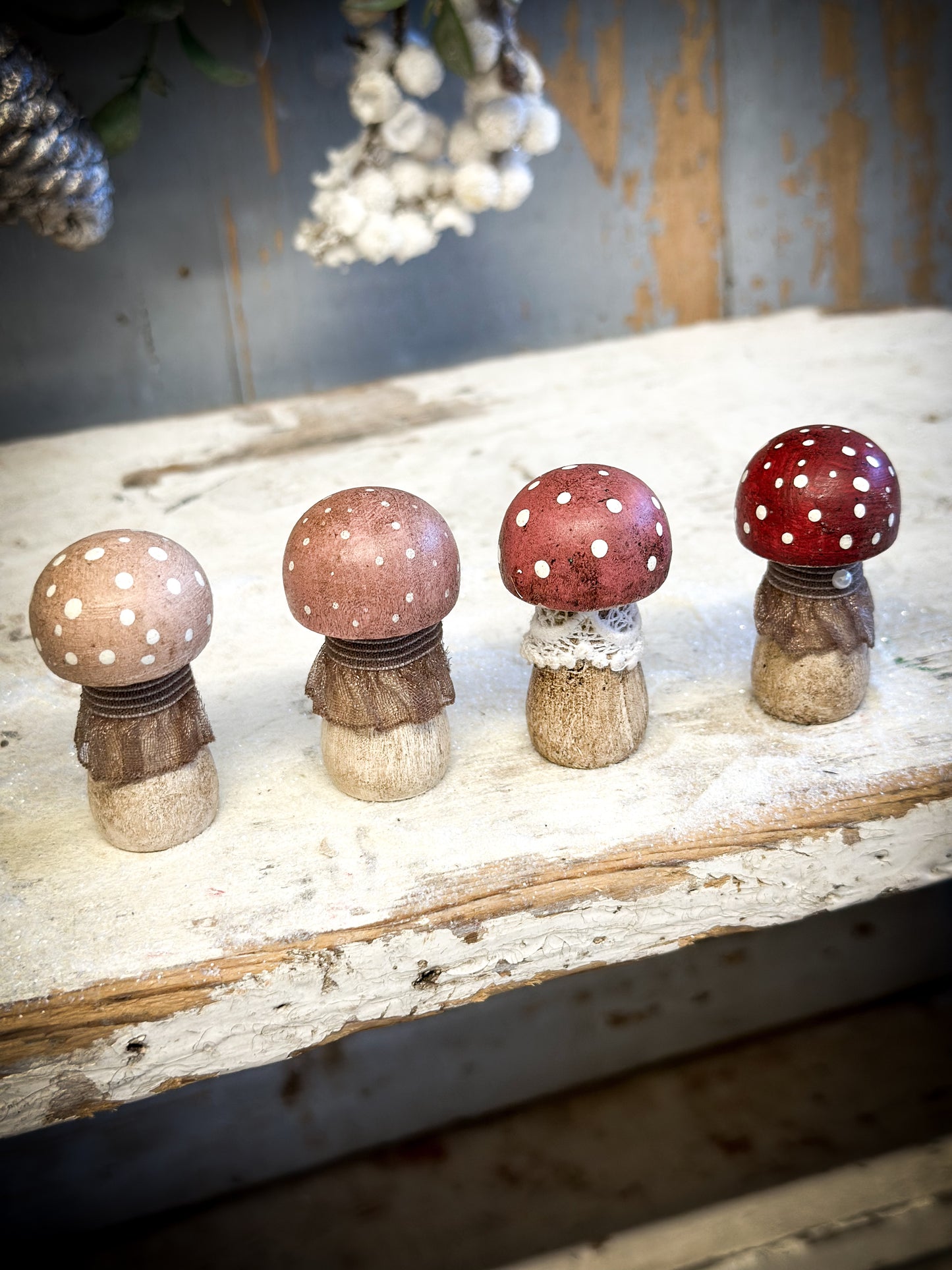 A wooden hand painted and trimmed Christmas village toadstool medium button one