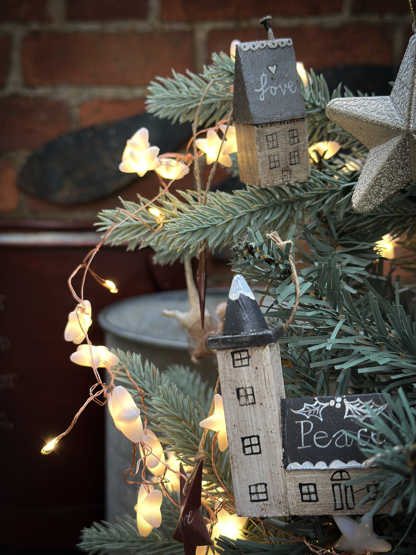 A pretty vintage German Erzgebirge Putz wooden village house painted with a Christmas quote