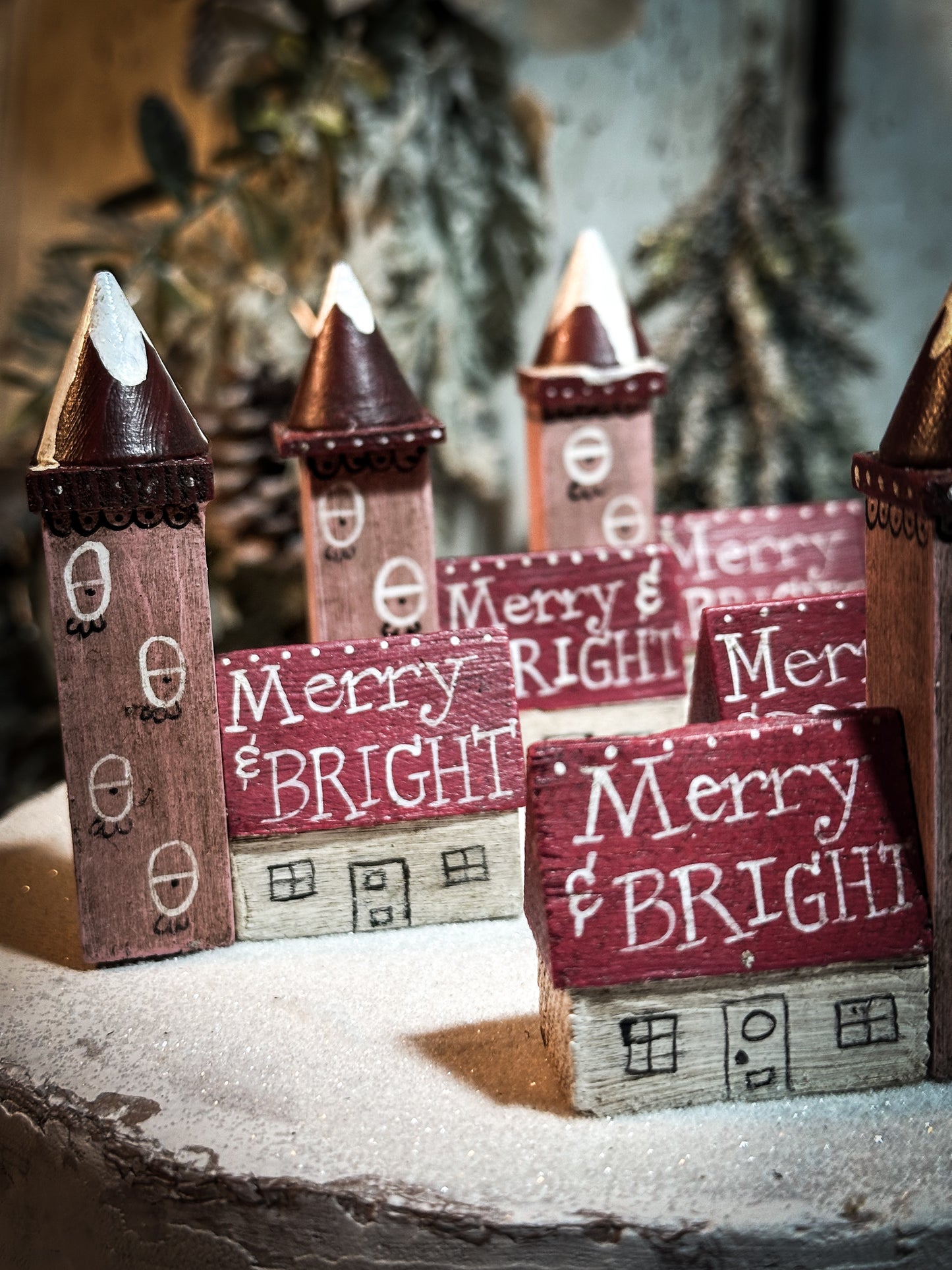 A pretty vintage German Erzgebirge Putz wooden village house painted with a Christmas quote