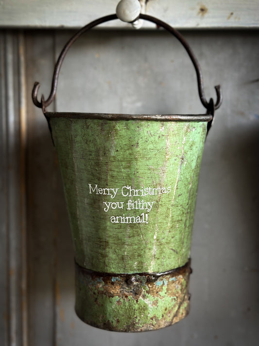 A Recycled Metal Mini Christmas Tree Bucket With A Hand Painted Quote