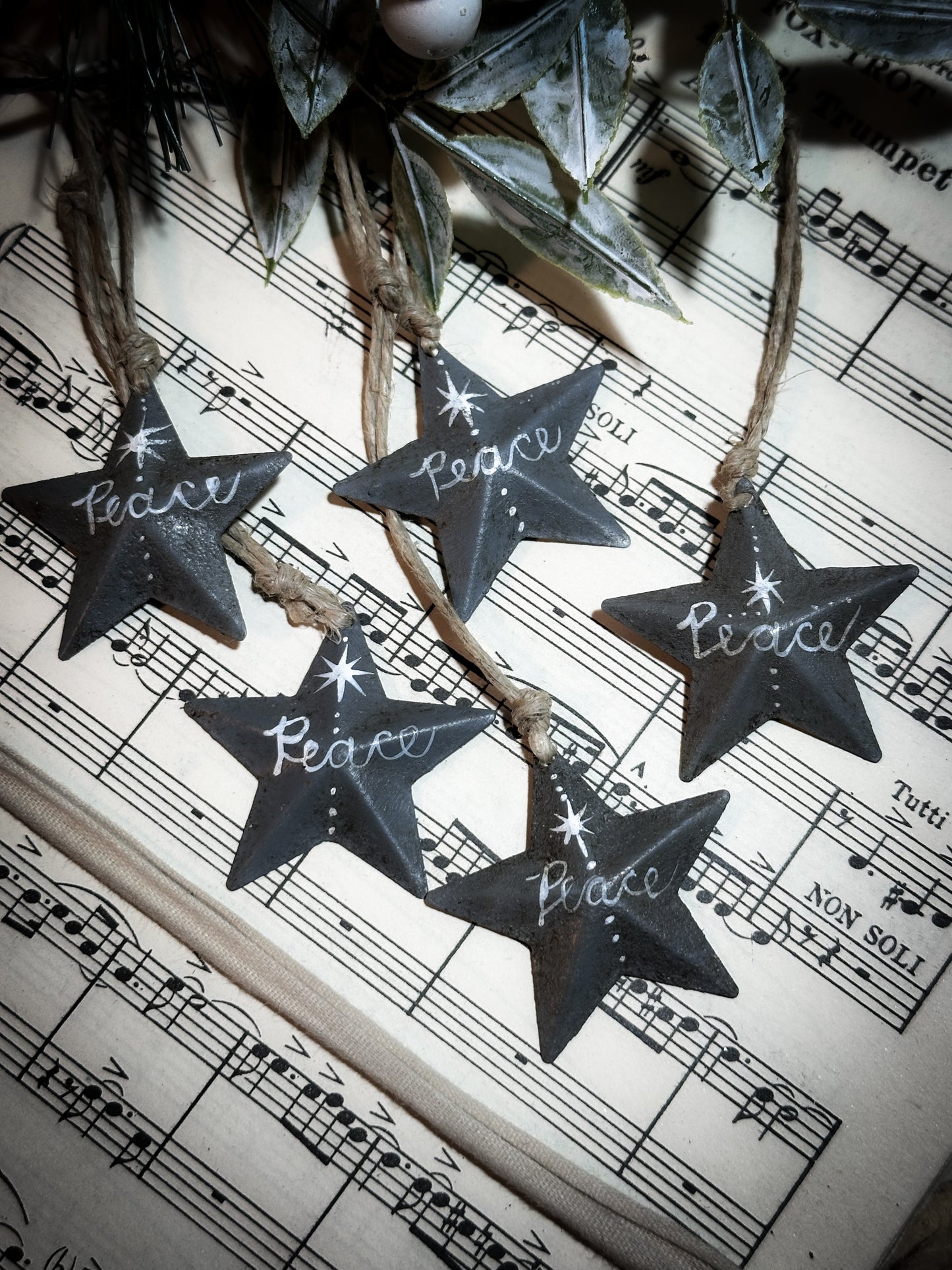 A mini tin barn star charcoal grey decoration hand painted with “Peace”