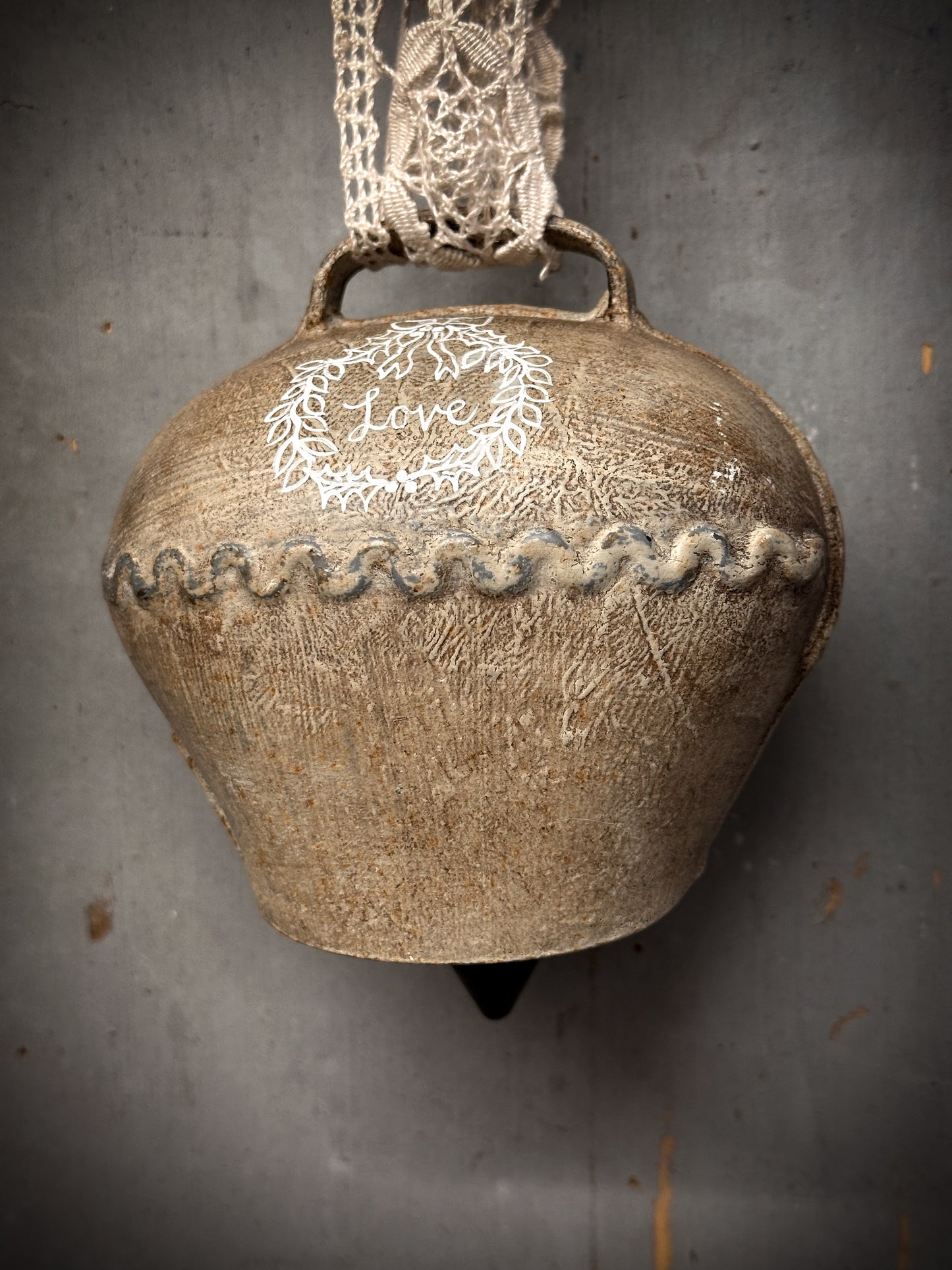 A Large Vintage Painted Cow Bell With a Hand Painted Quote