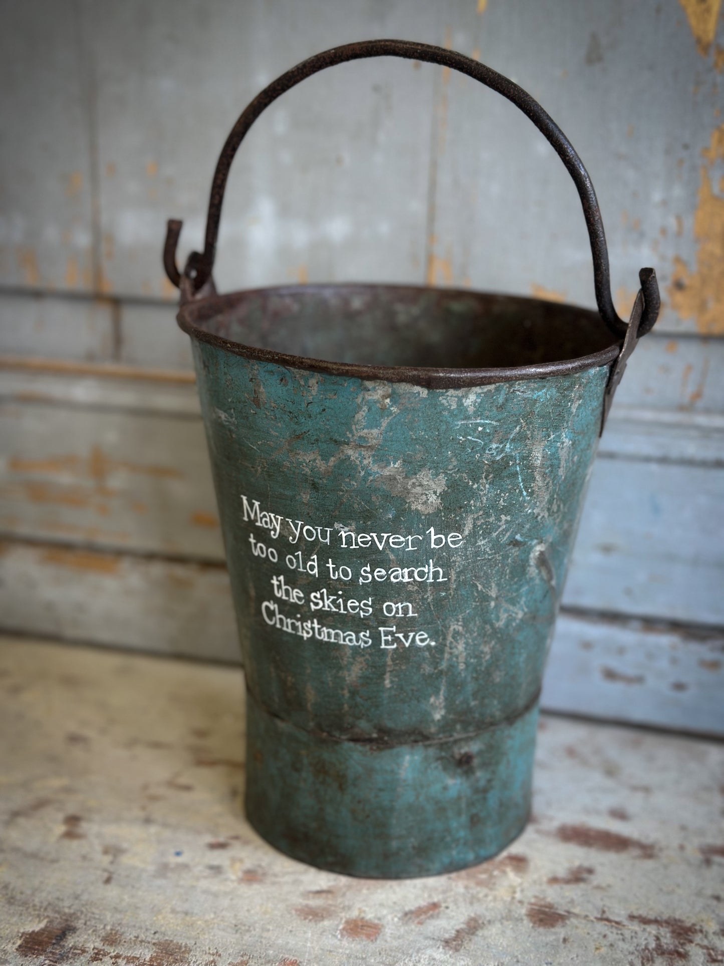 A Recycled Metal Mini Christmas Tree Bucket With A Hand Painted Quote