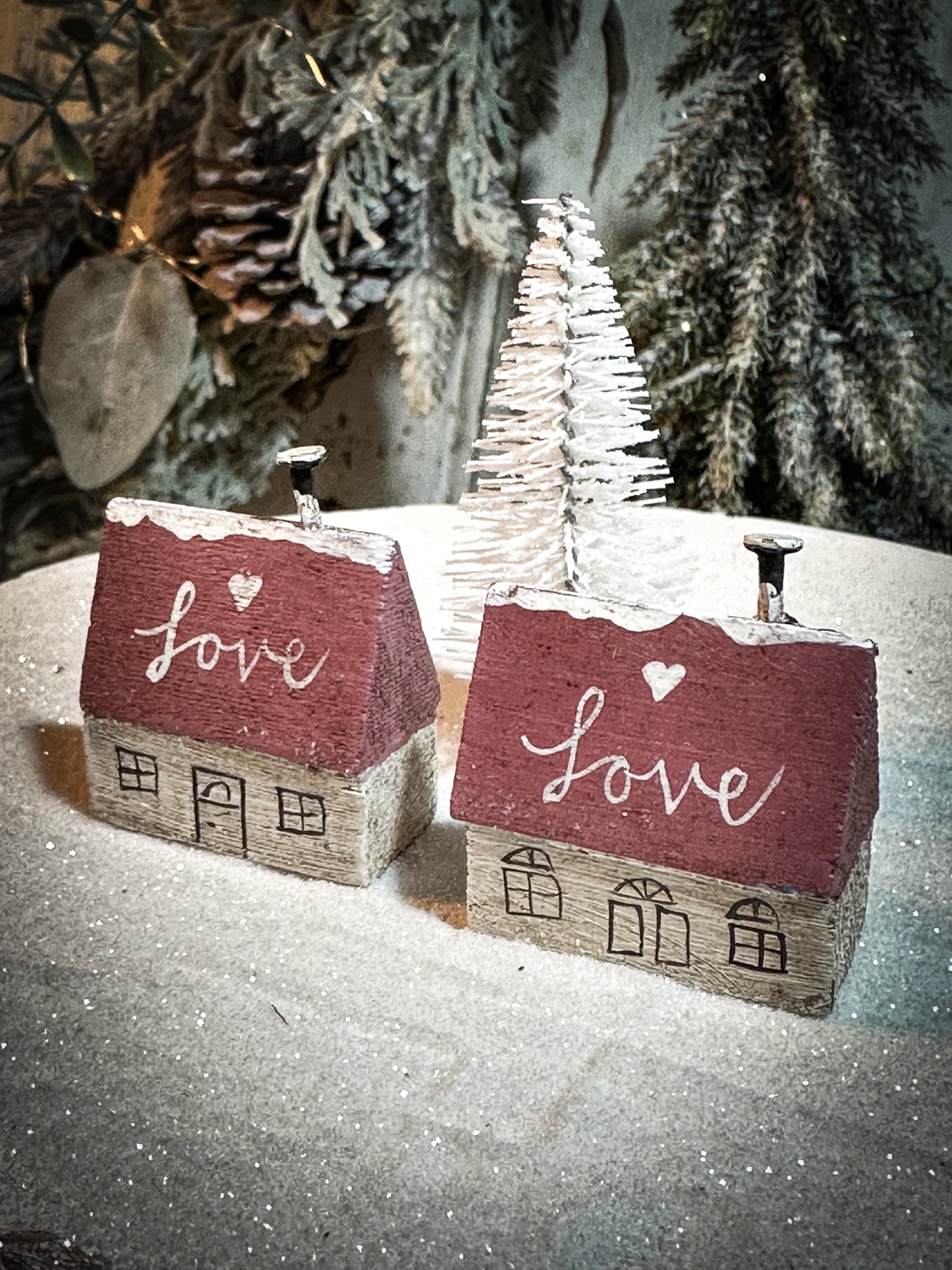 A pretty vintage German Erzgebirge Putz wooden village house painted with a Christmas quote