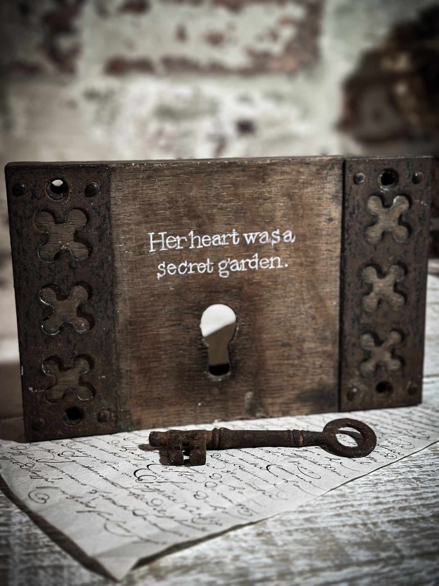 A salvaged original door lock with a painted quote