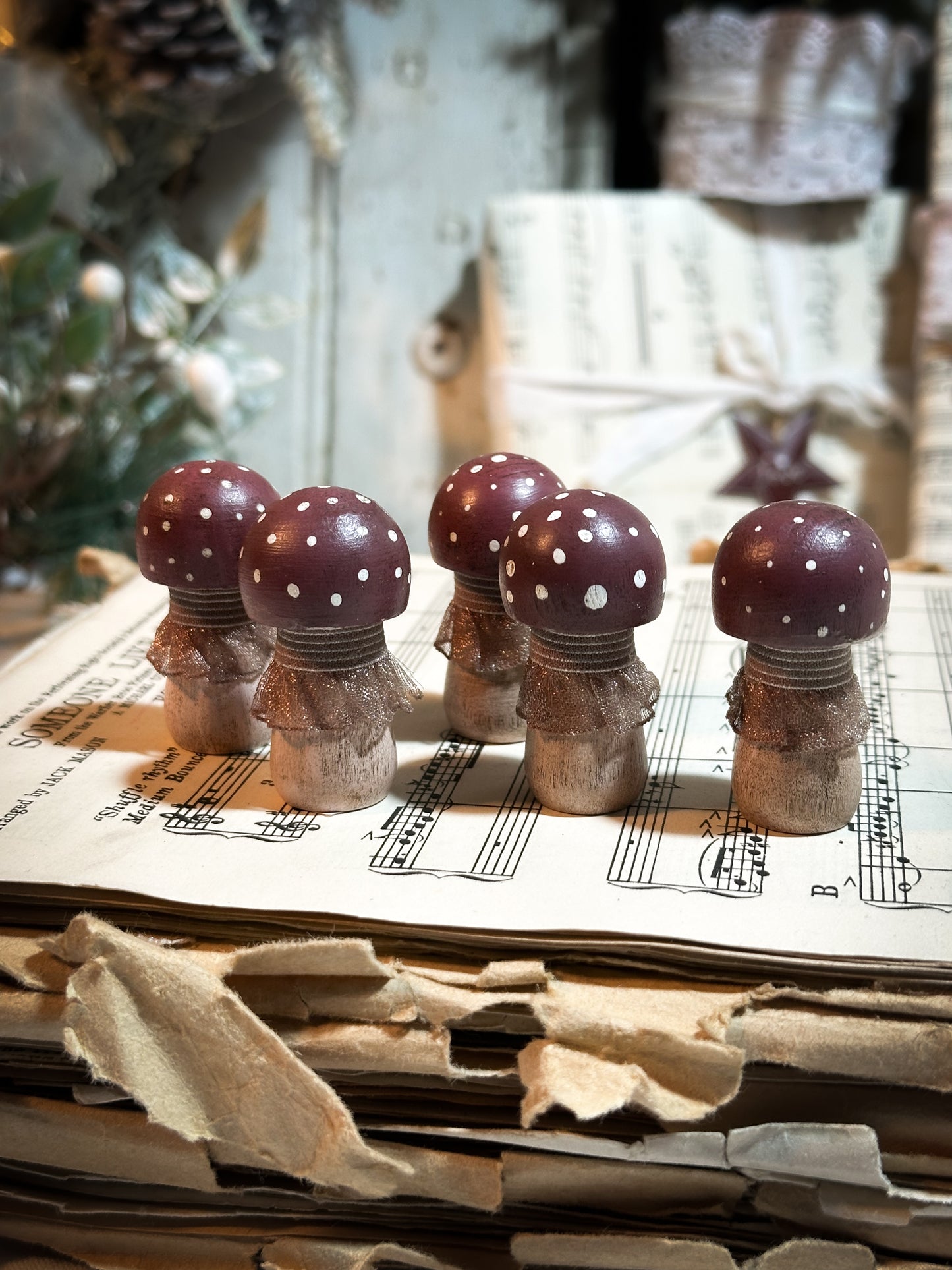 A wooden hand painted and trimmed Christmas village toadstool