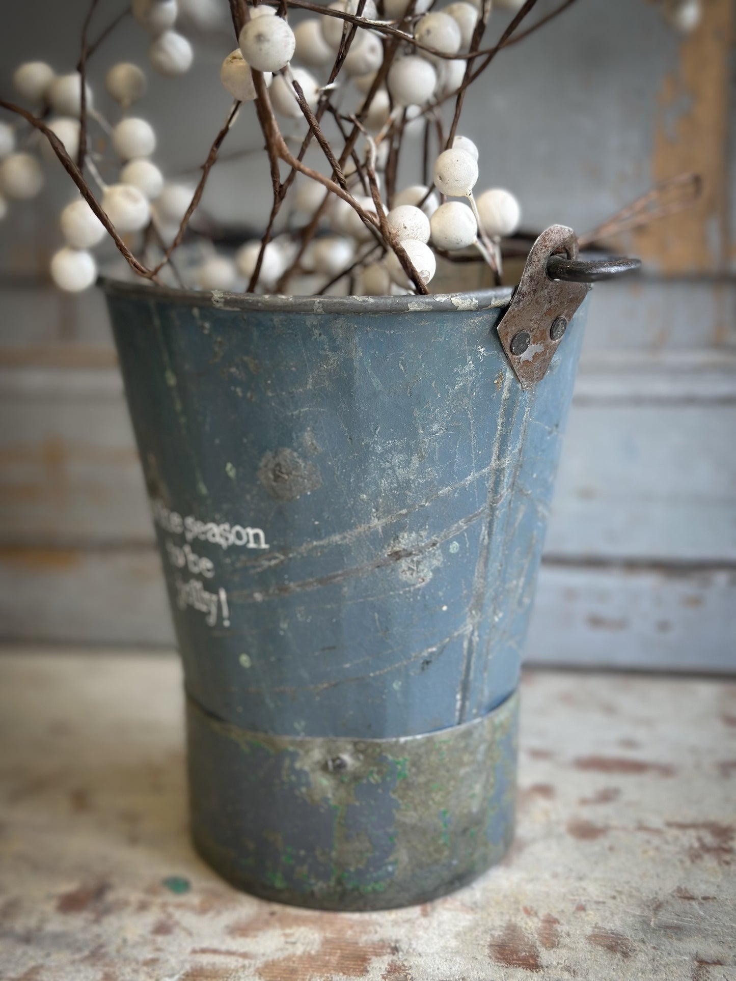 A Recycled Metal Mini Christmas Tree Bucket With A Hand Painted Quote
