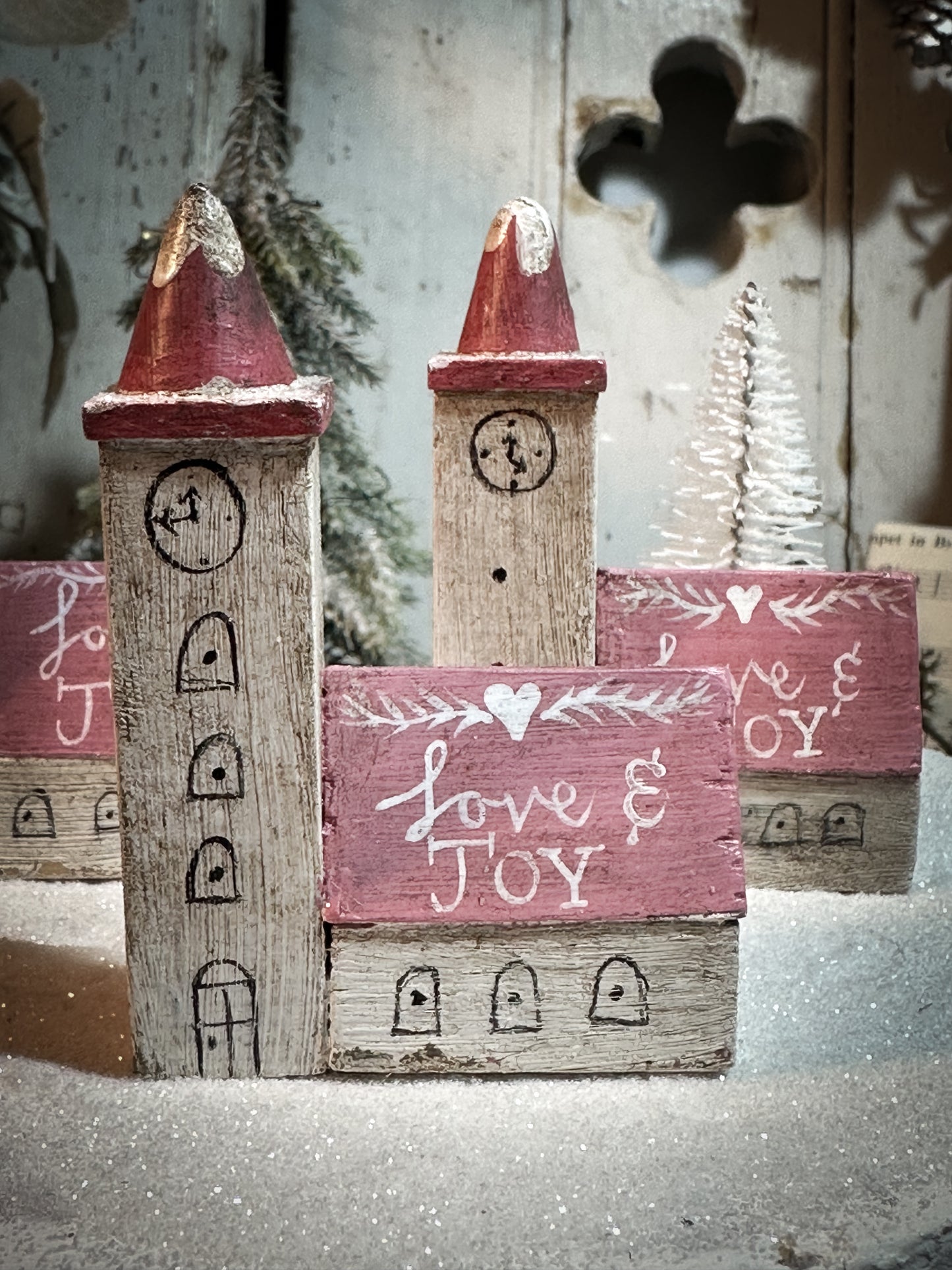 A pretty vintage German Erzgebirge Putz wooden village house painted with a Christmas quote