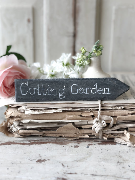 A small hand painted Victorian Welsh slate sign in lower case “Cutting Garden”