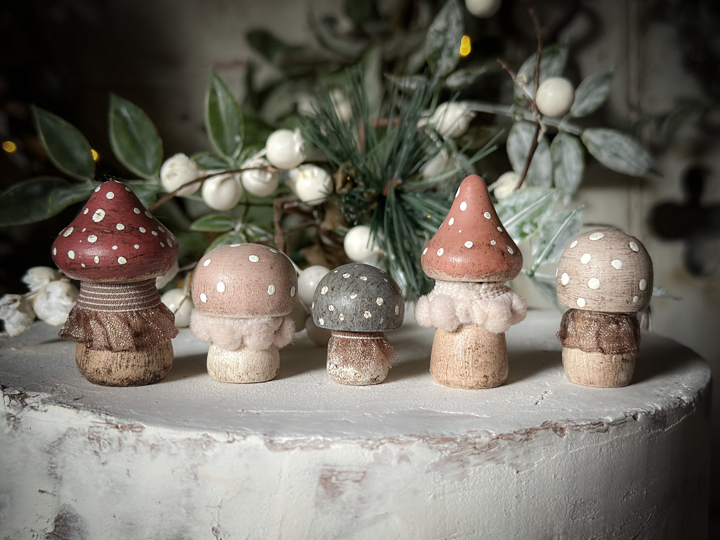 A set of five wooden hand painted and trimmed Christmas village toadstools