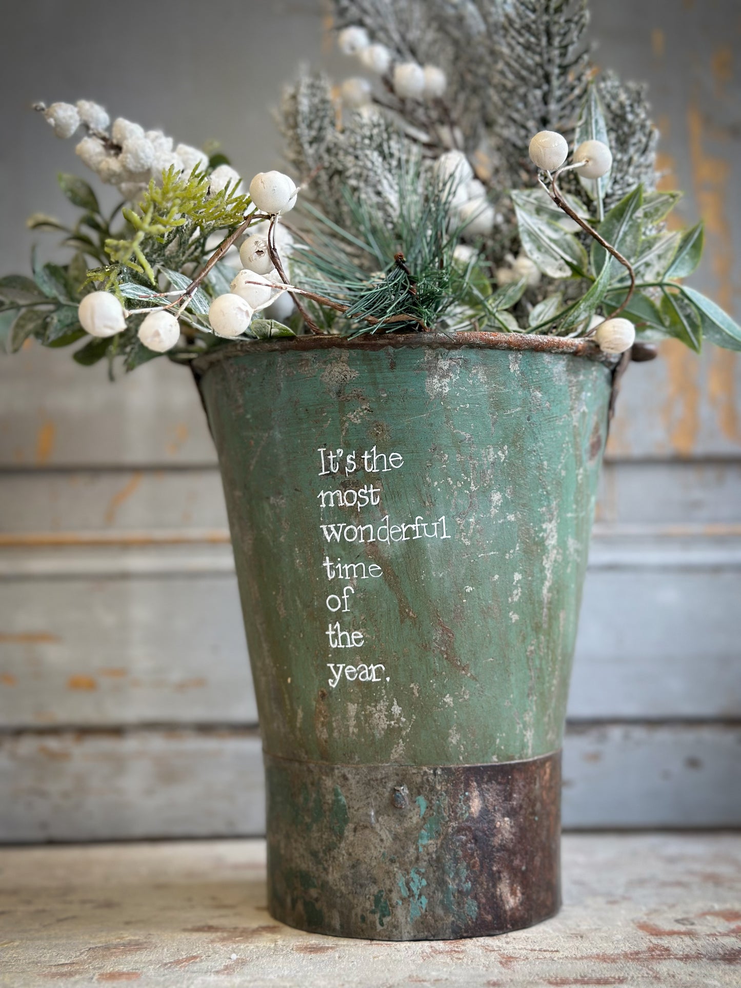 A Recycled Metal Mini Christmas Tree Bucket With A Hand Painted Quote