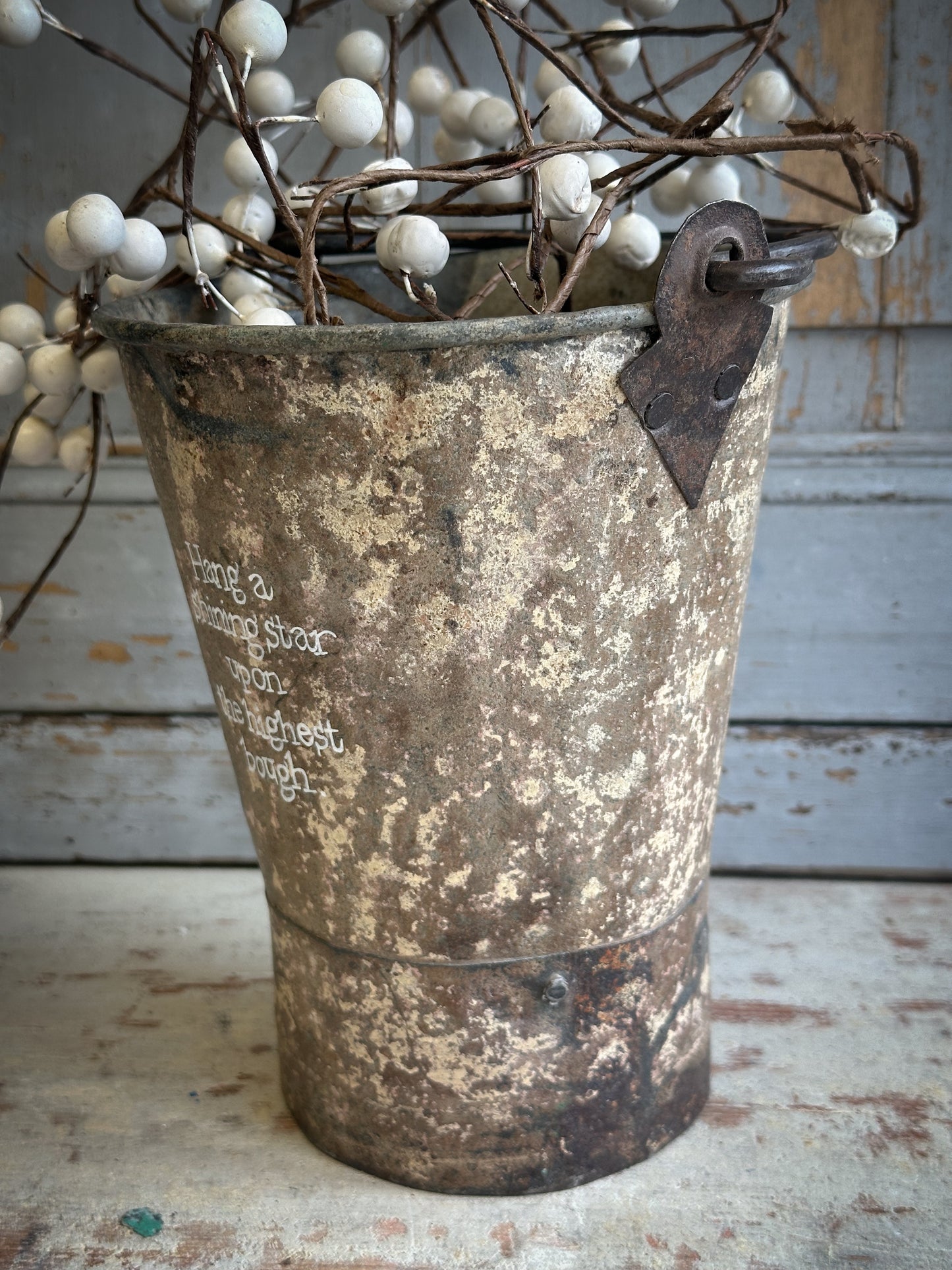 A Recycled Metal Mini Christmas Tree Bucket With A Hand Painted Quote