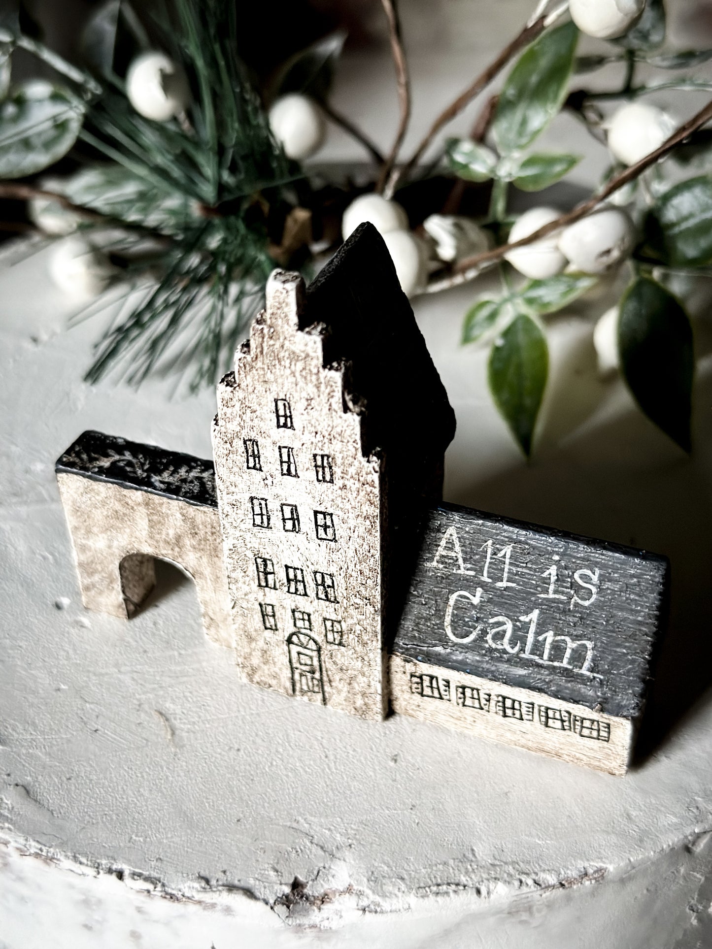 A pretty vintage German Erzgebirge Putz wooden village house painted with a Christmas quote