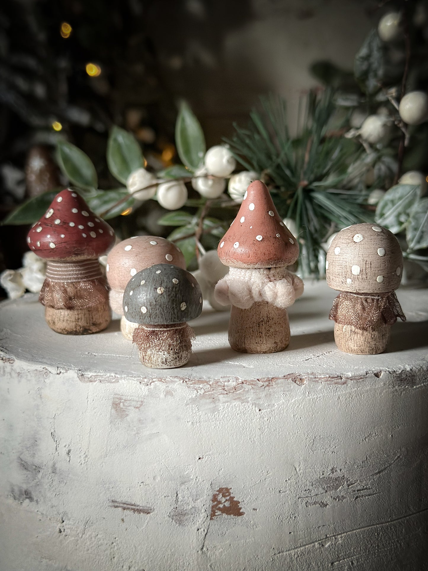 A set of five wooden hand painted and trimmed Christmas village toadstools