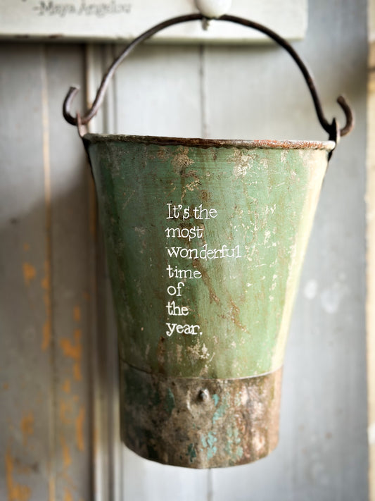 A Recycled Metal Mini Christmas Tree Bucket With A Hand Painted Quote