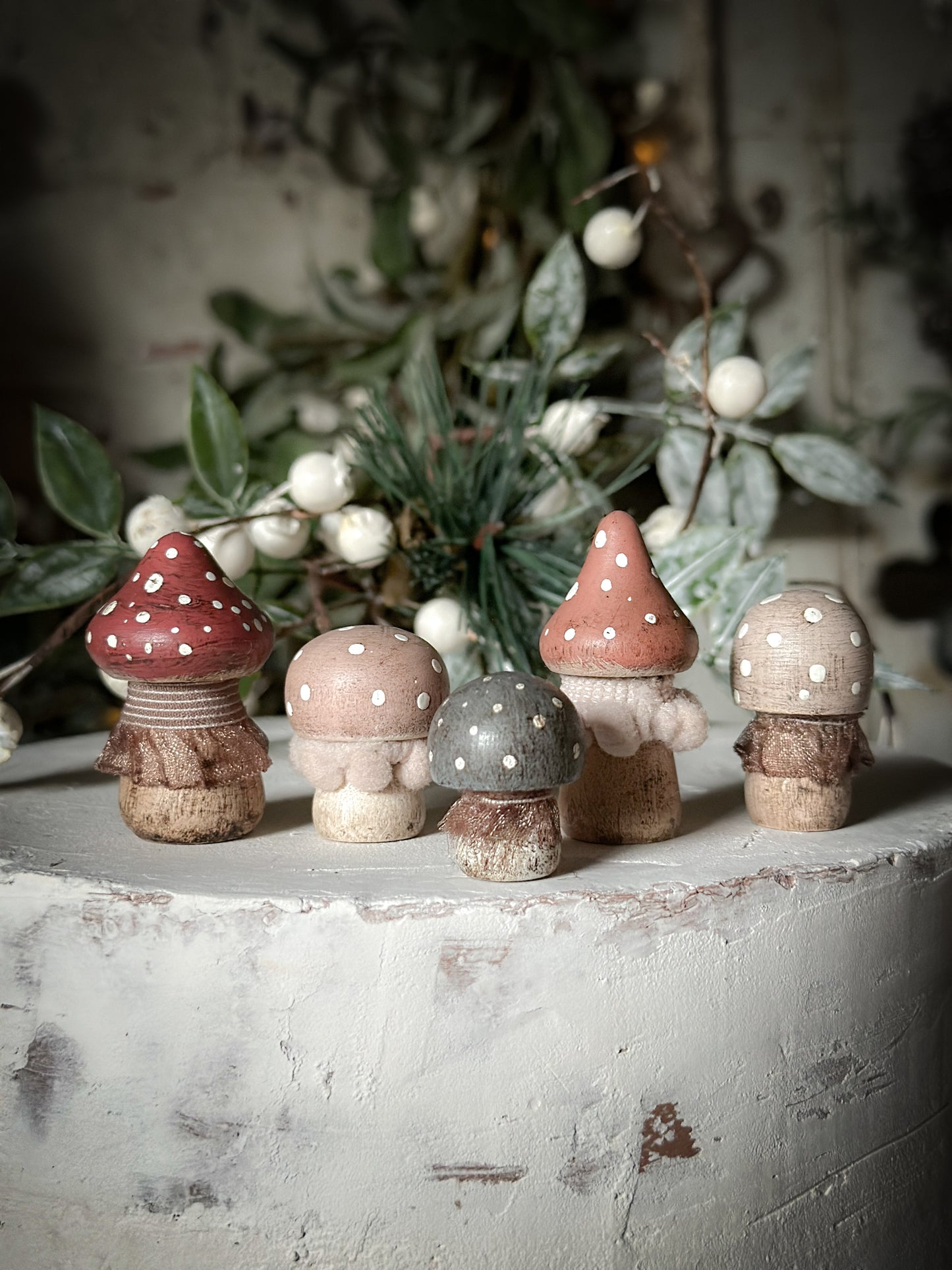 A set of five wooden hand painted and trimmed Christmas village toadstools