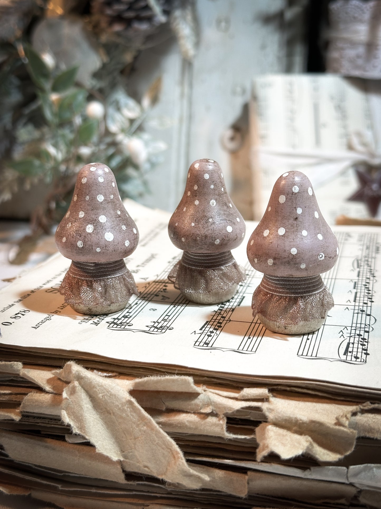 A wooden hand painted and trimmed Christmas village toadstool