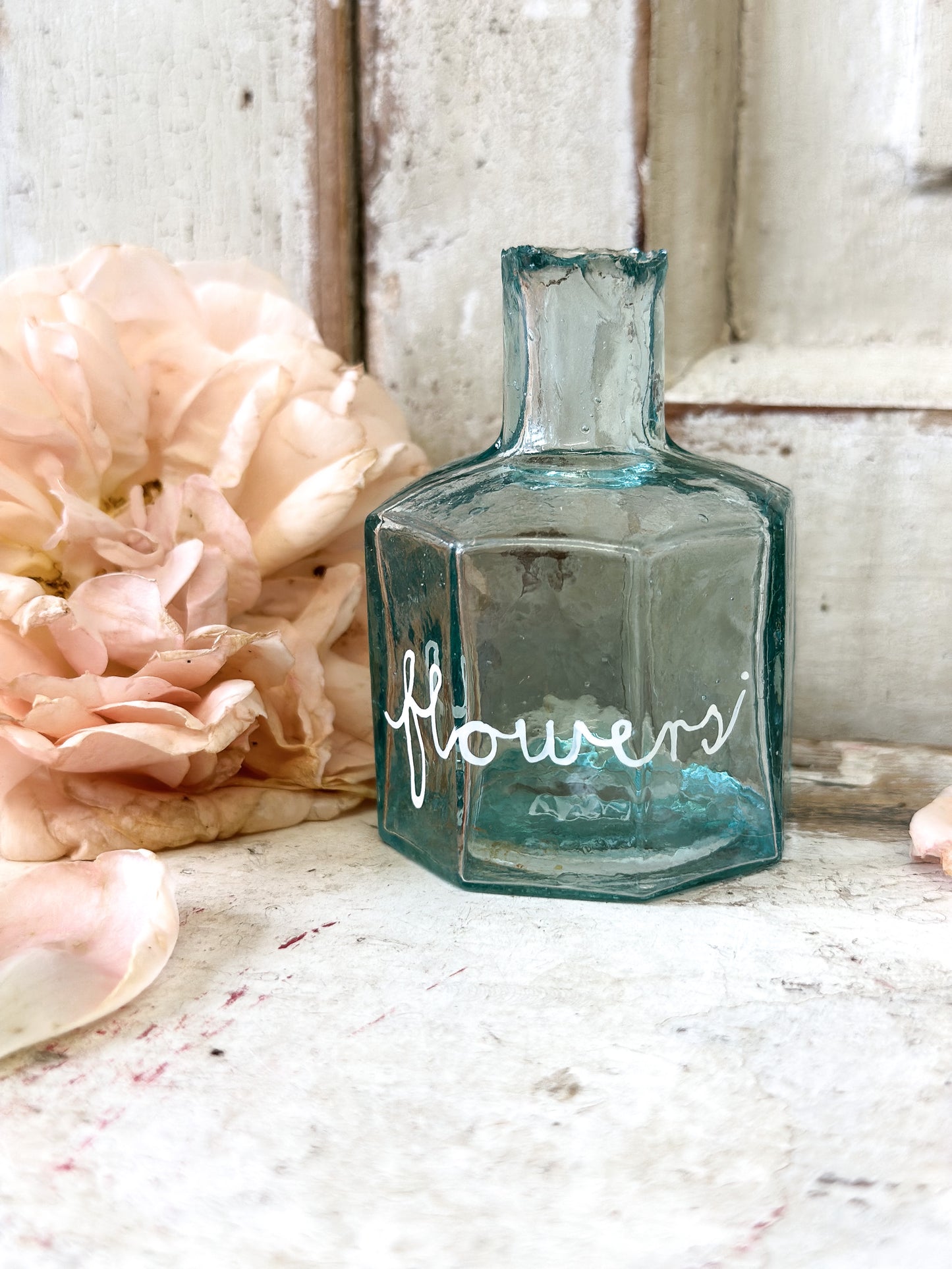 A beautiful Victorian bottle with a hand painted quote “Flowers”