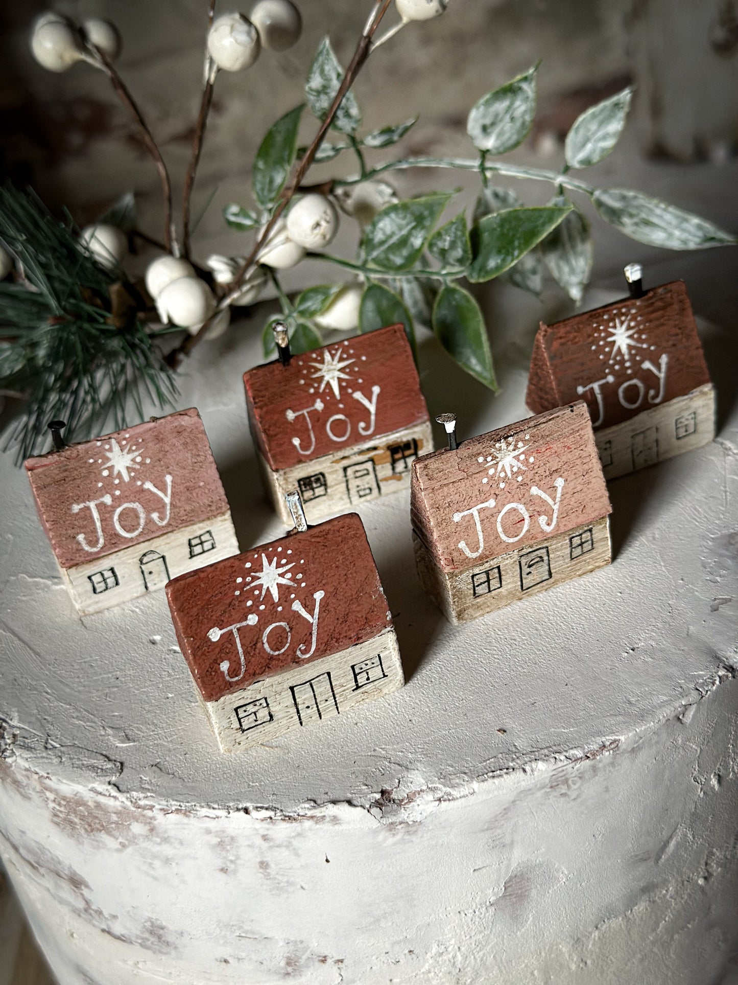 A pretty vintage German Erzgebirge Putz wooden village house painted with a Christmas quote