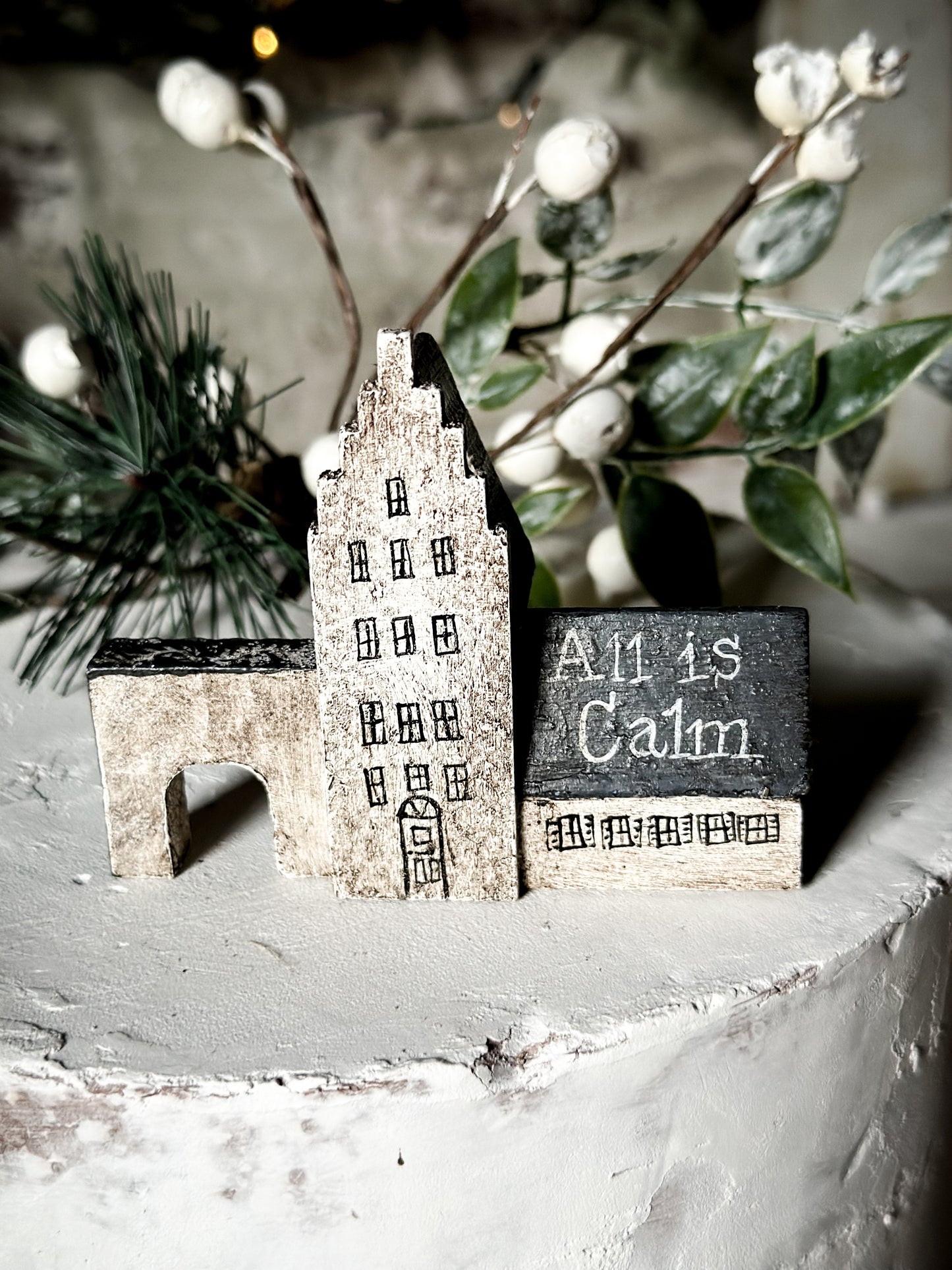 A pretty vintage German Erzgebirge Putz wooden village house painted with a Christmas quote