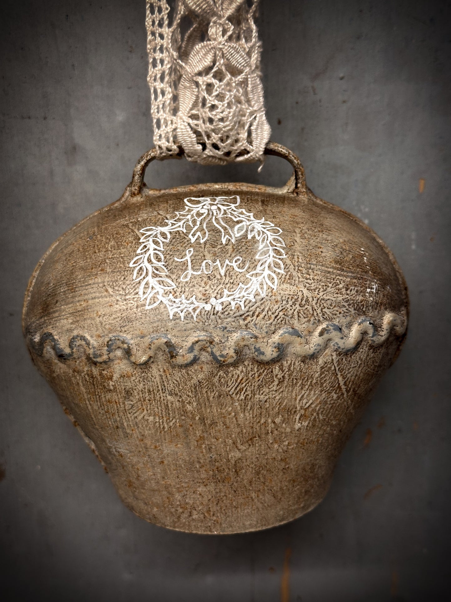 A Large Vintage Painted Cow Bell With a Hand Painted Quote