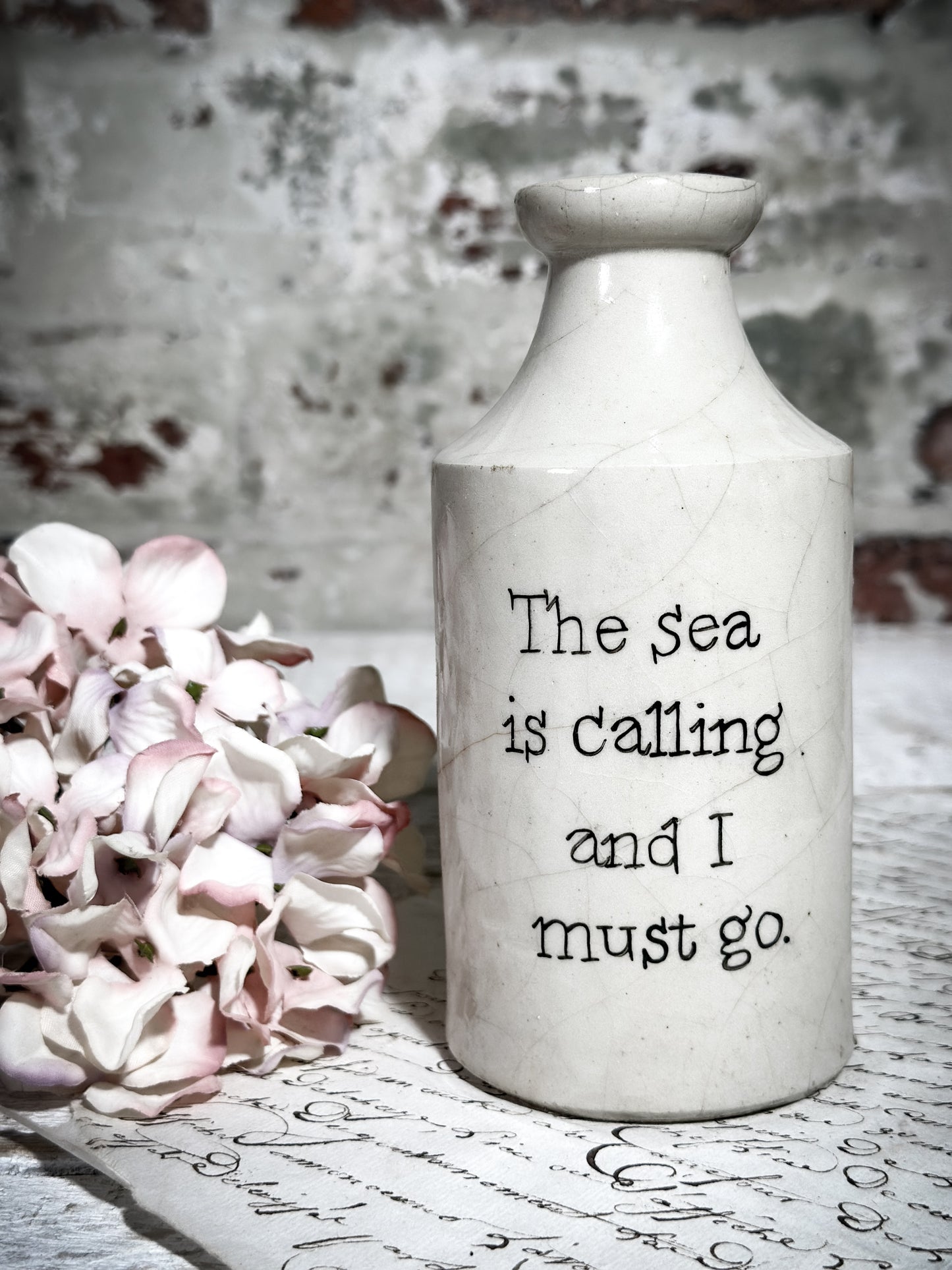 An Antique Pottery Bottle with a Hand Painted Inspirational Quote