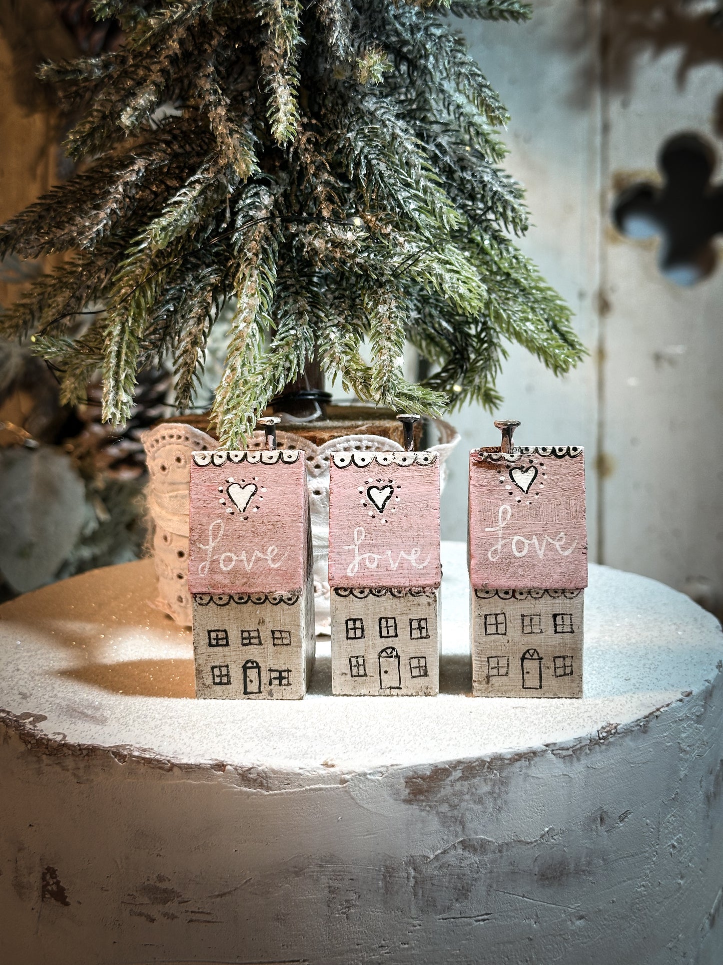 A pretty vintage German Erzgebirge Putz wooden village house painted with a Christmas quote