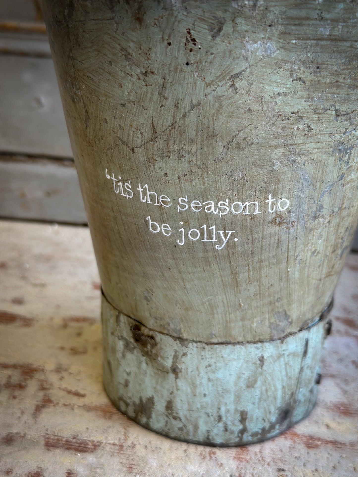 A Recycled Metal Mini Christmas Tree Bucket With A Hand Painted Quote