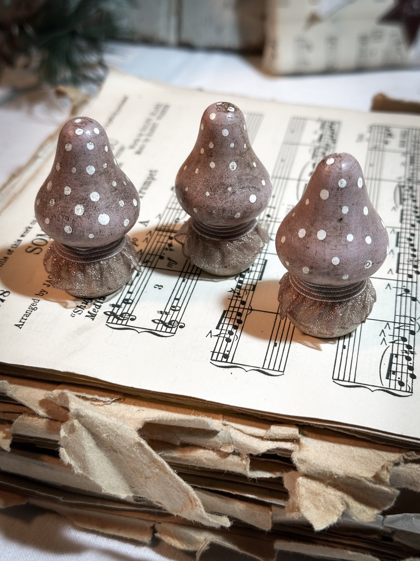 A wooden hand painted and trimmed Christmas village toadstool