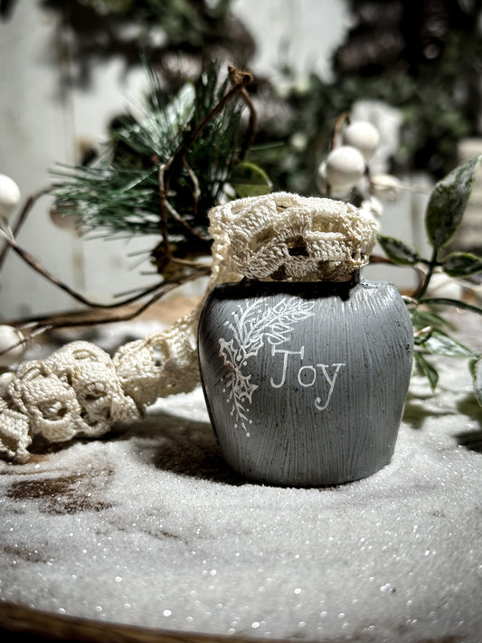 A vintage painted cow bell with a hand painted quote