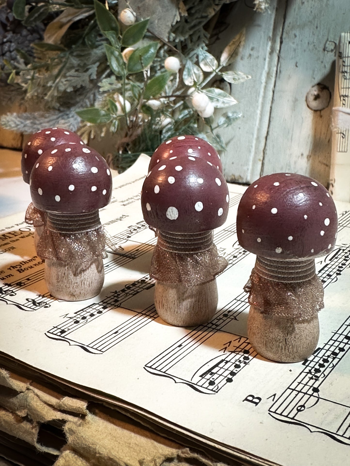 A wooden hand painted and trimmed Christmas village toadstool