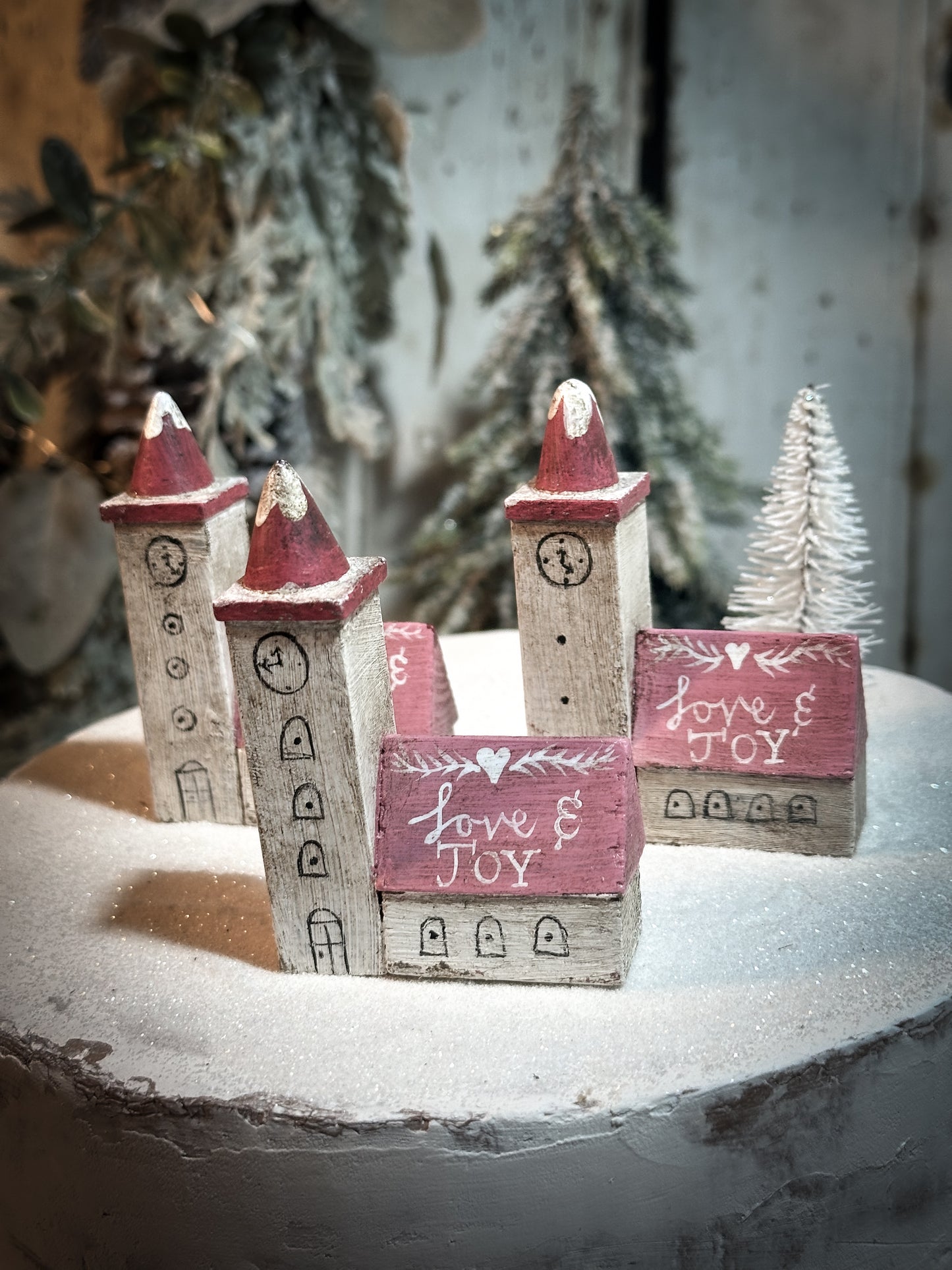 A pretty vintage German Erzgebirge Putz wooden village house painted with a Christmas quote