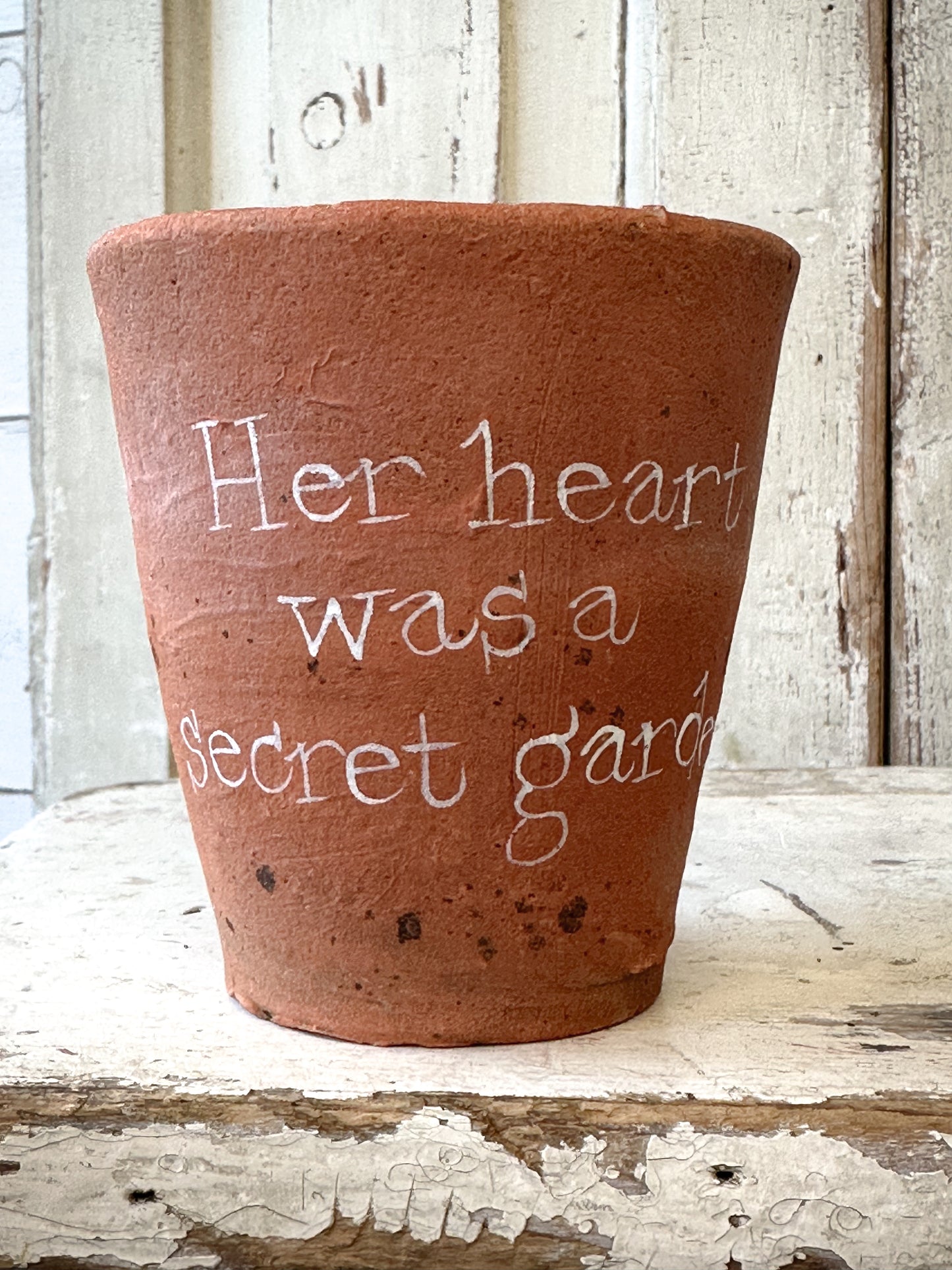 A Victorian terracotta pot with a quote “ Her heart was a Secret Garden”