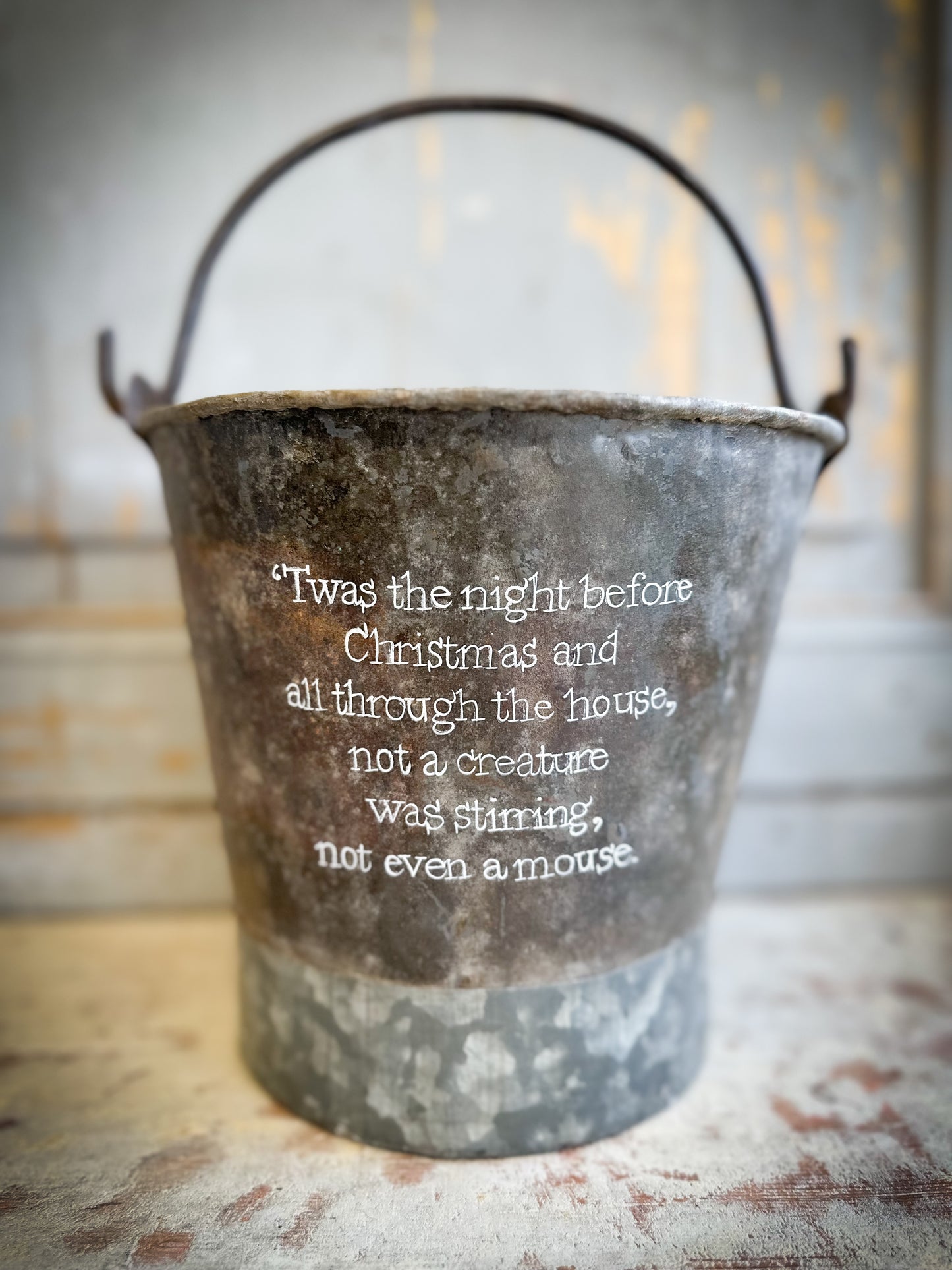 A Recycled Metal Small Christmas Tree Bucket With A Hand Painted Quote