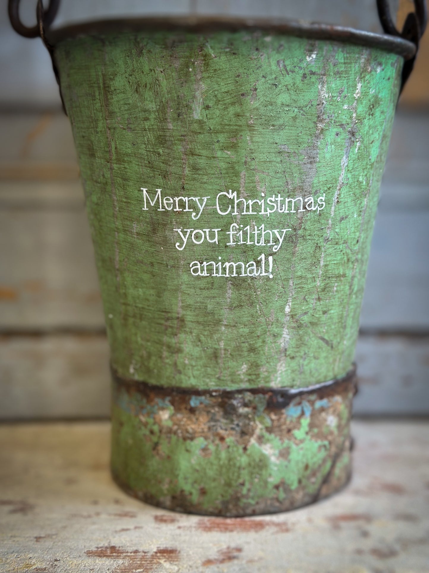 A Recycled Metal Mini Christmas Tree Bucket With A Hand Painted Quote