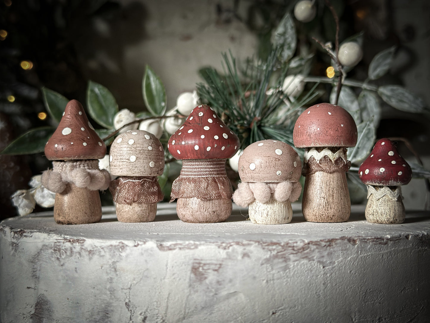 A set of six wooden hand painted and trimmed Christmas village mushrooms