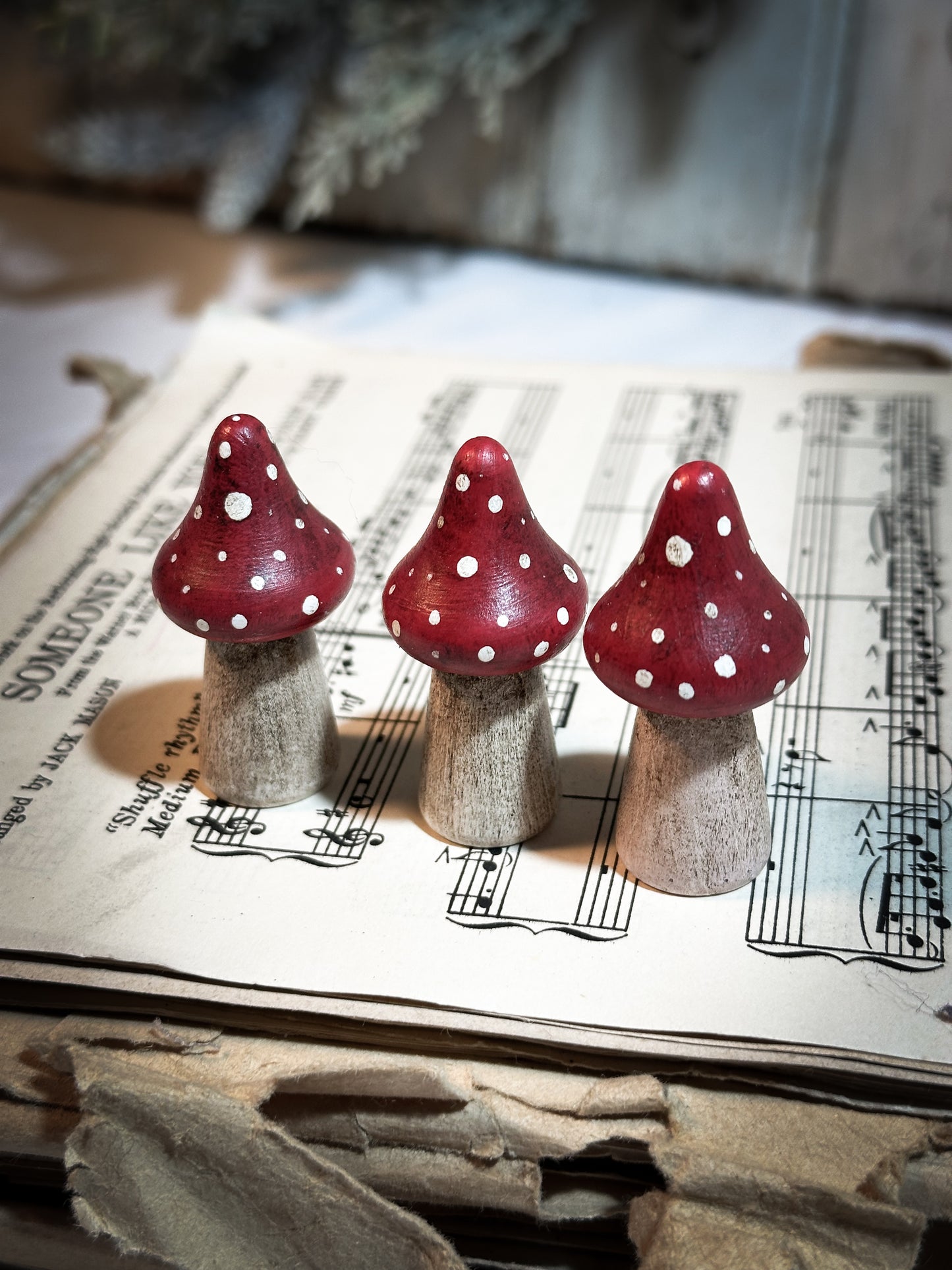 A wooden hand painted Christmas village toadstool