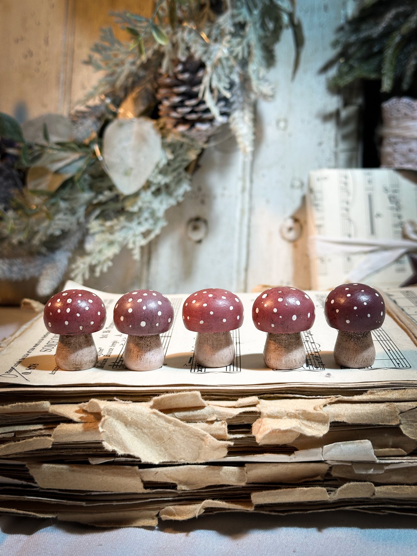 A wooden hand painted Christmas village toadstool