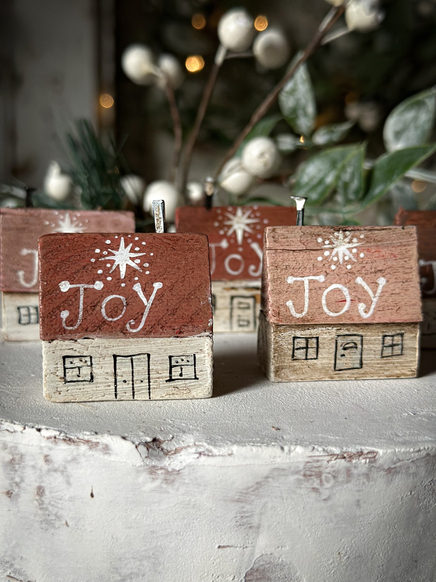 A pretty vintage German Erzgebirge Putz wooden village house painted with a Christmas quote