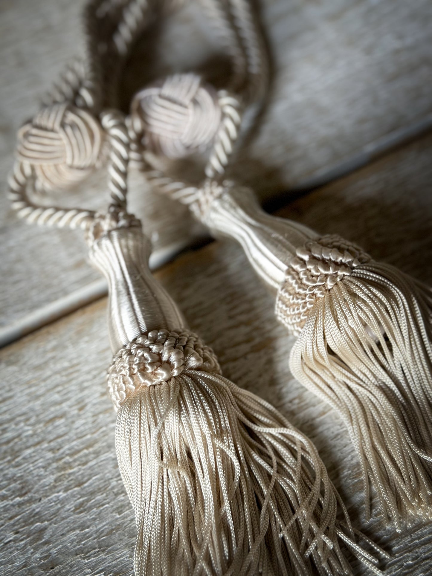 A pair of pretty vintage ivory curtain tie backs