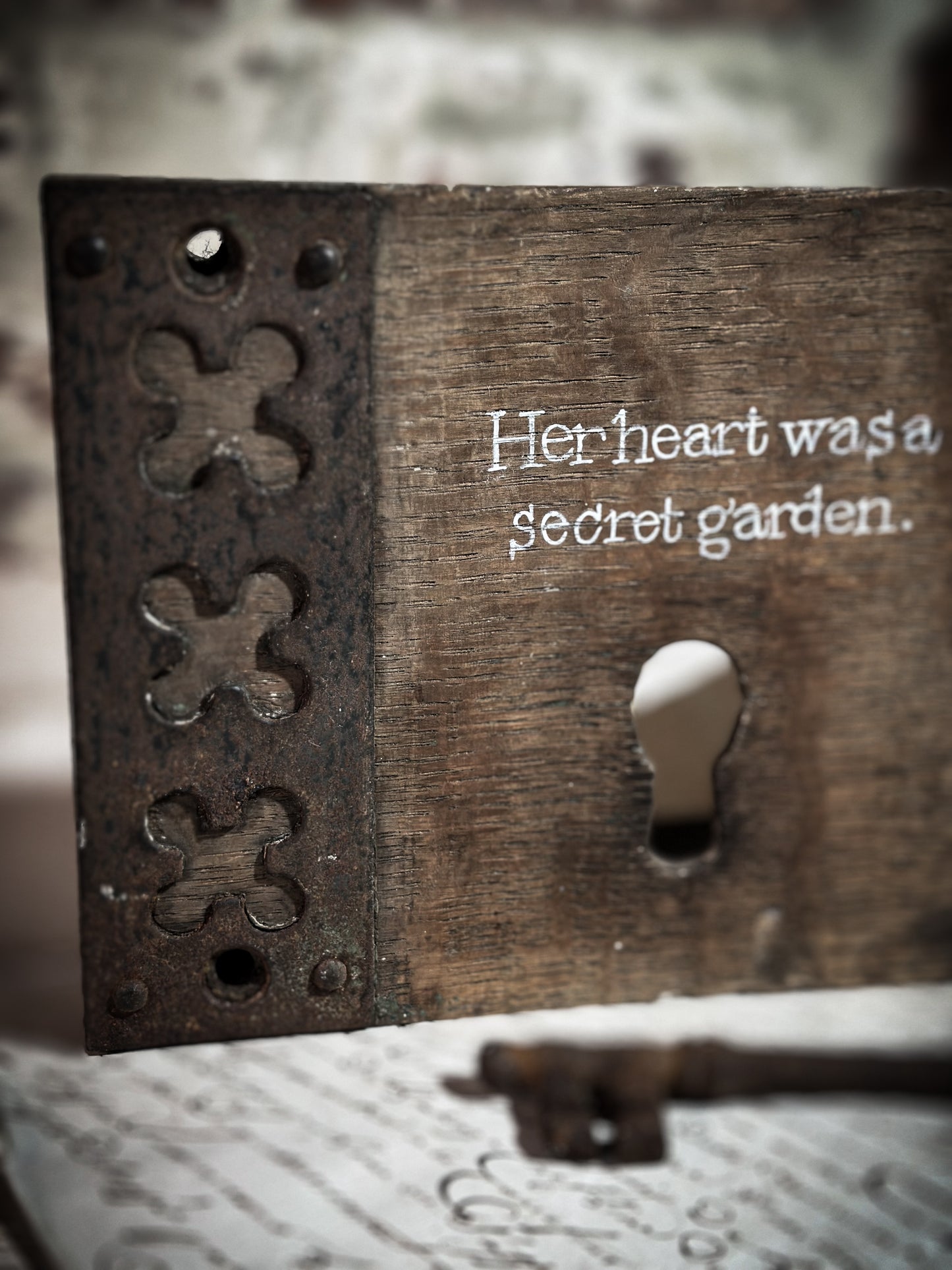 A salvaged original door lock with a painted quote