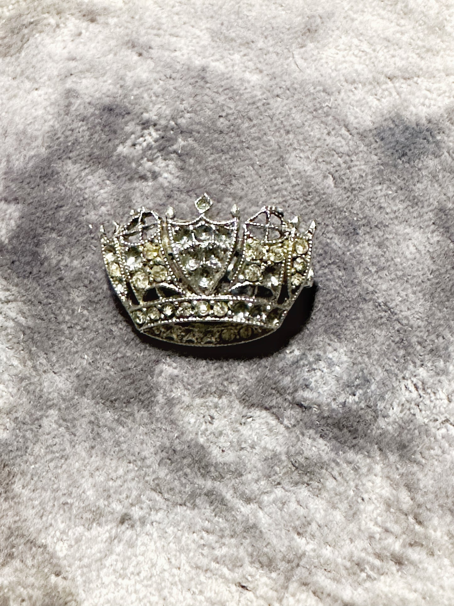 A tiny diamanté crown brooch