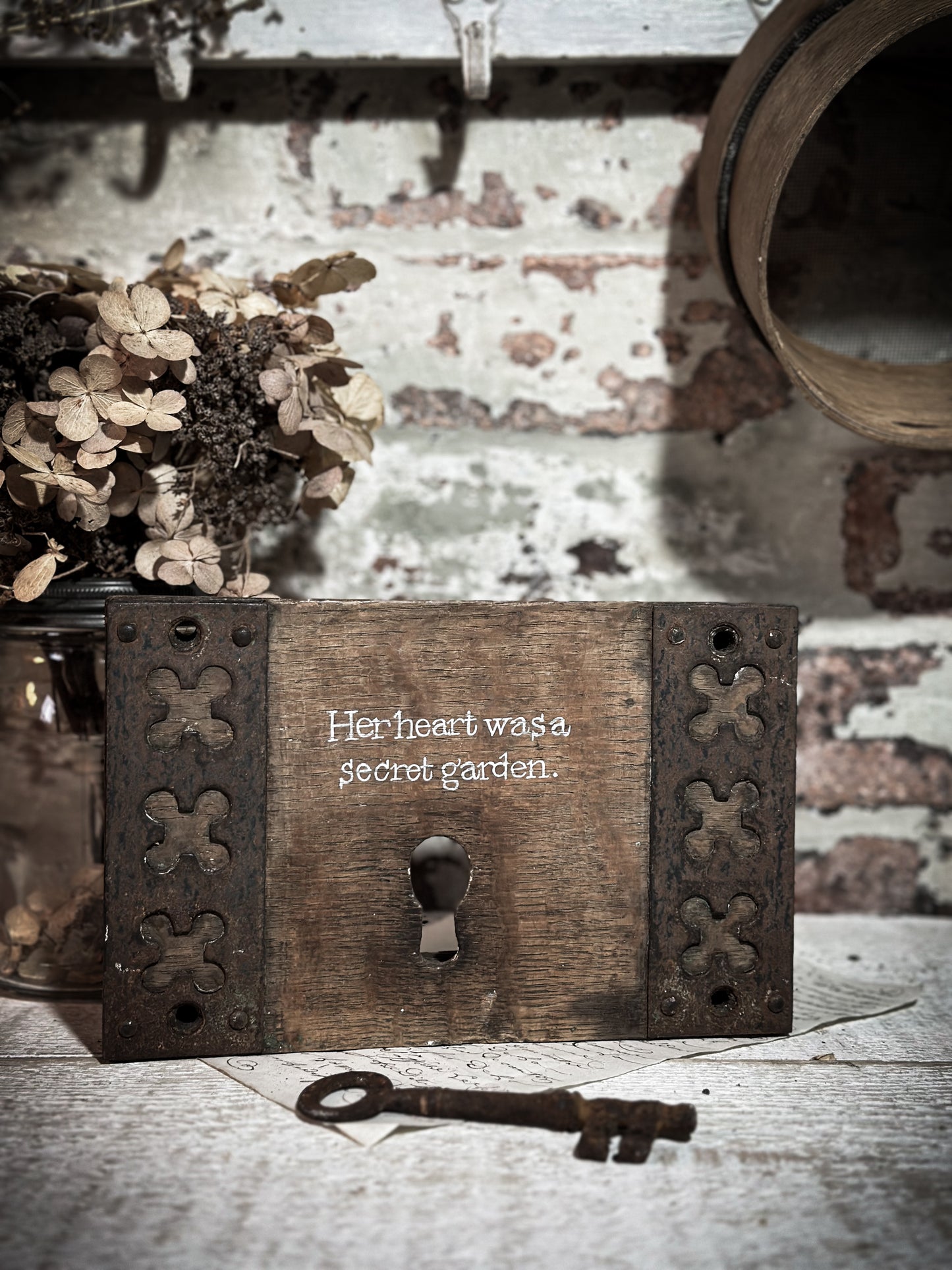 A salvaged original door lock with a painted quote